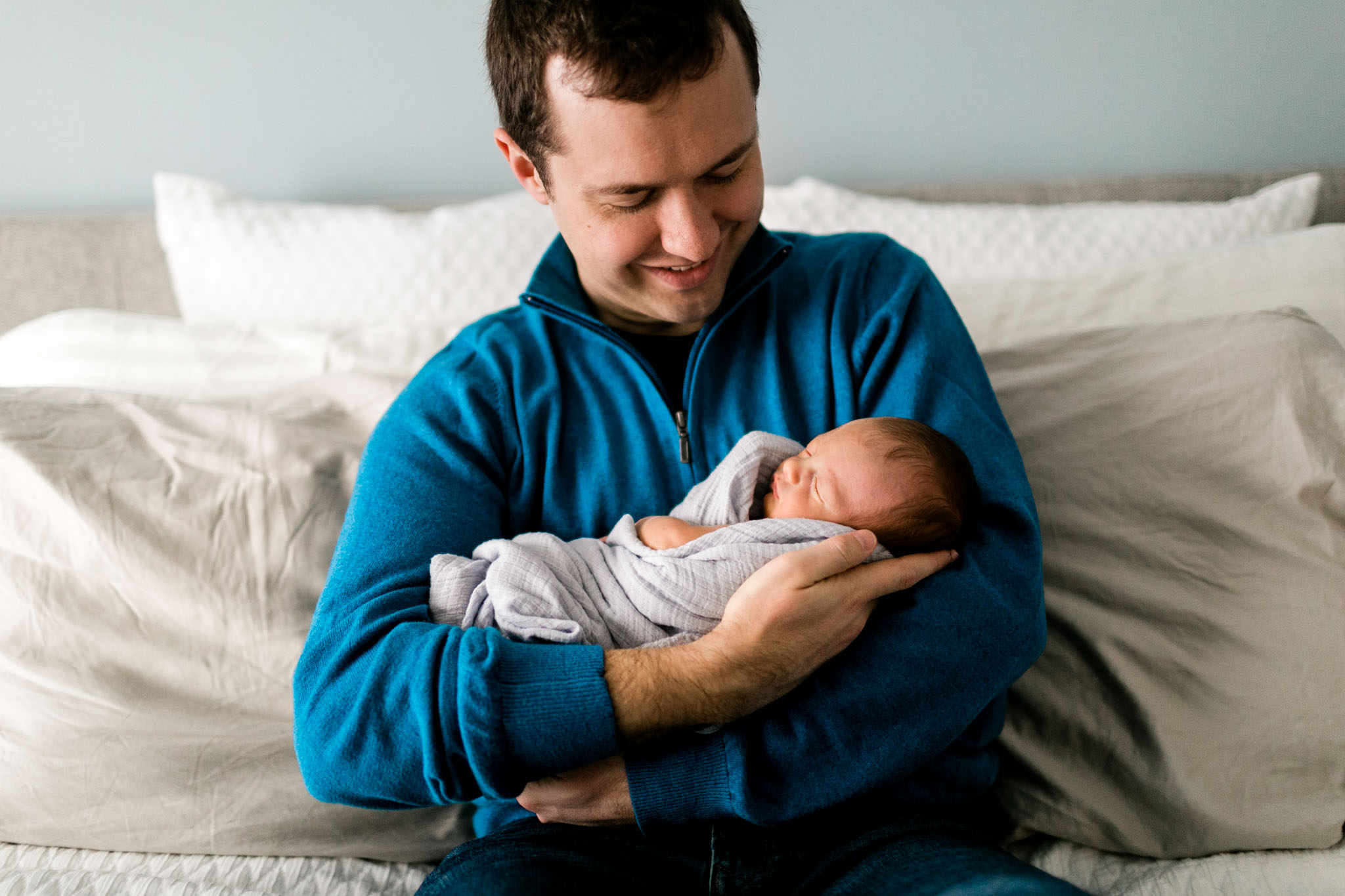 Father holding baby boy in arms | Raleigh Newborn Photographer | By G. Lin Photography