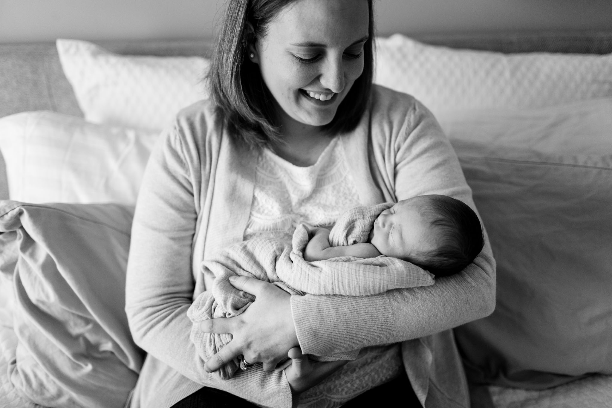 Newborn Photographer in Raleigh NC | By G. Lin Photography | Black and white photo of mother holding baby at home