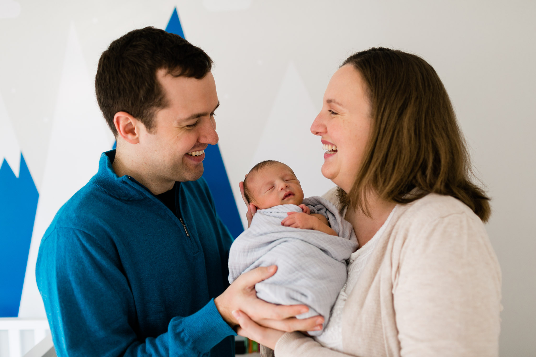 Parents laughing and holding baby | Newborn Photographer in Durham NC | By G. Lin Photography