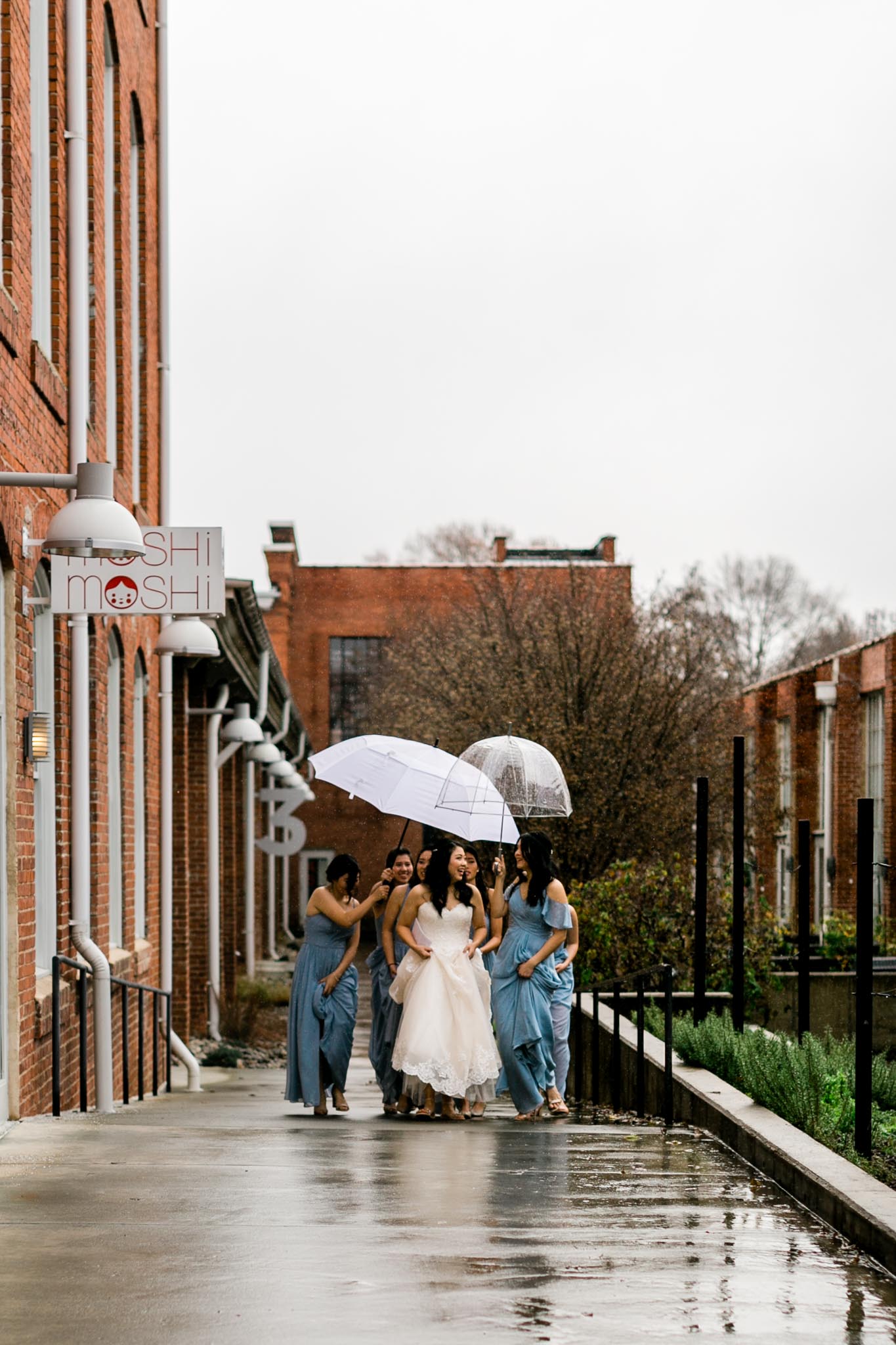 Bridal party walking in the rain at The Cotton Room | Durham Wedding Photographer | By G. Lin Photography