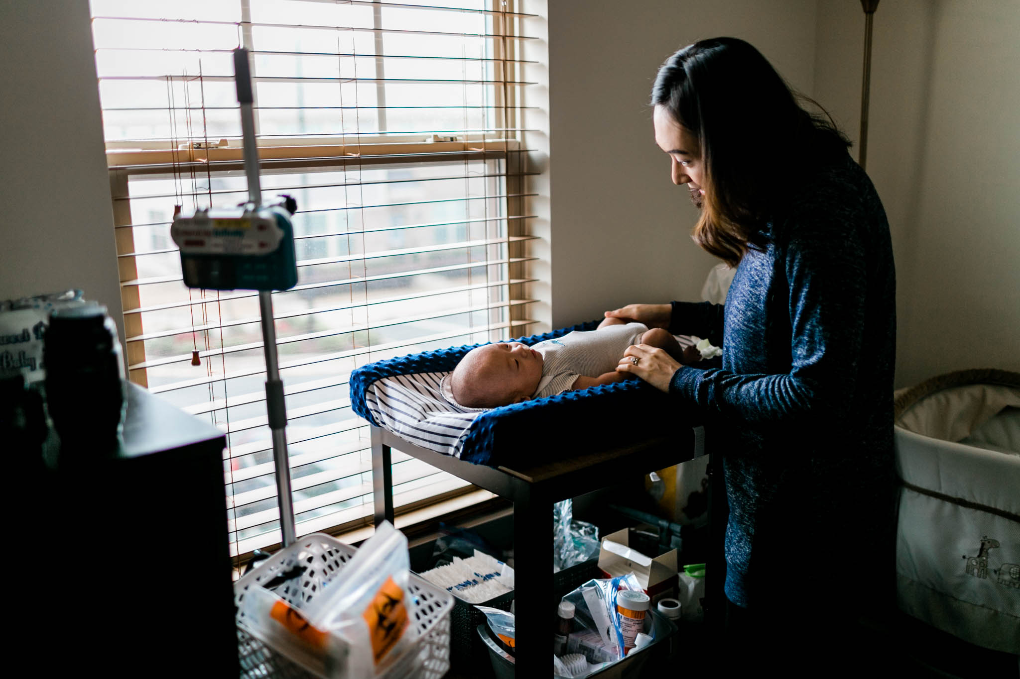 Mother helping preemie baby at home | Durham Newborn Photography | By G. Lin Photography
