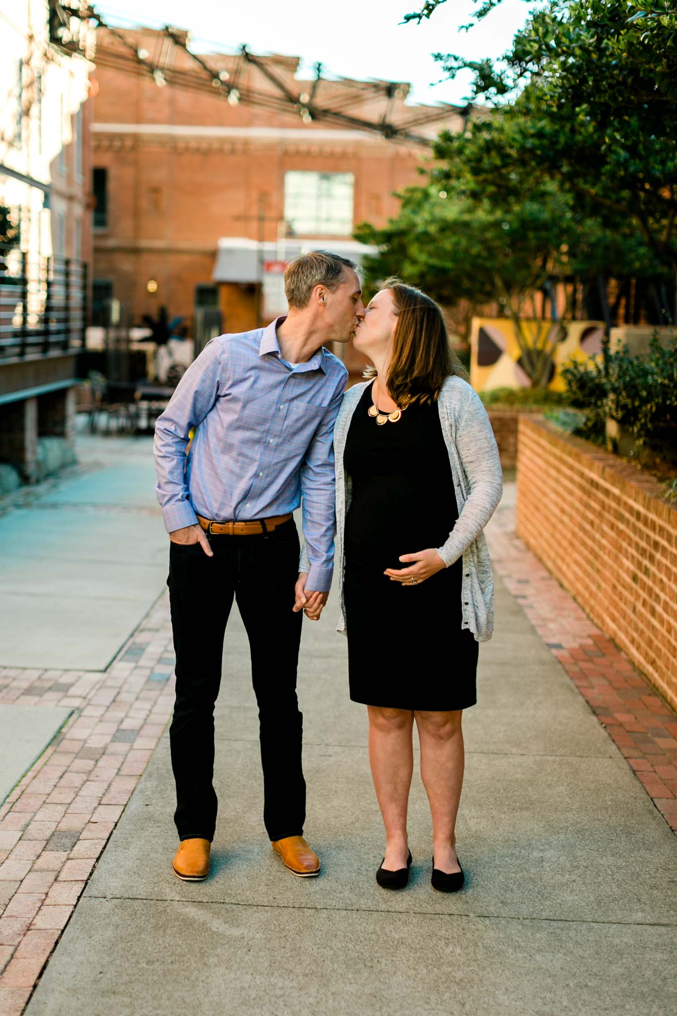 Couple kissing at American Tobacco Campus | Durham Maternity Photography | By G. Lin Photography