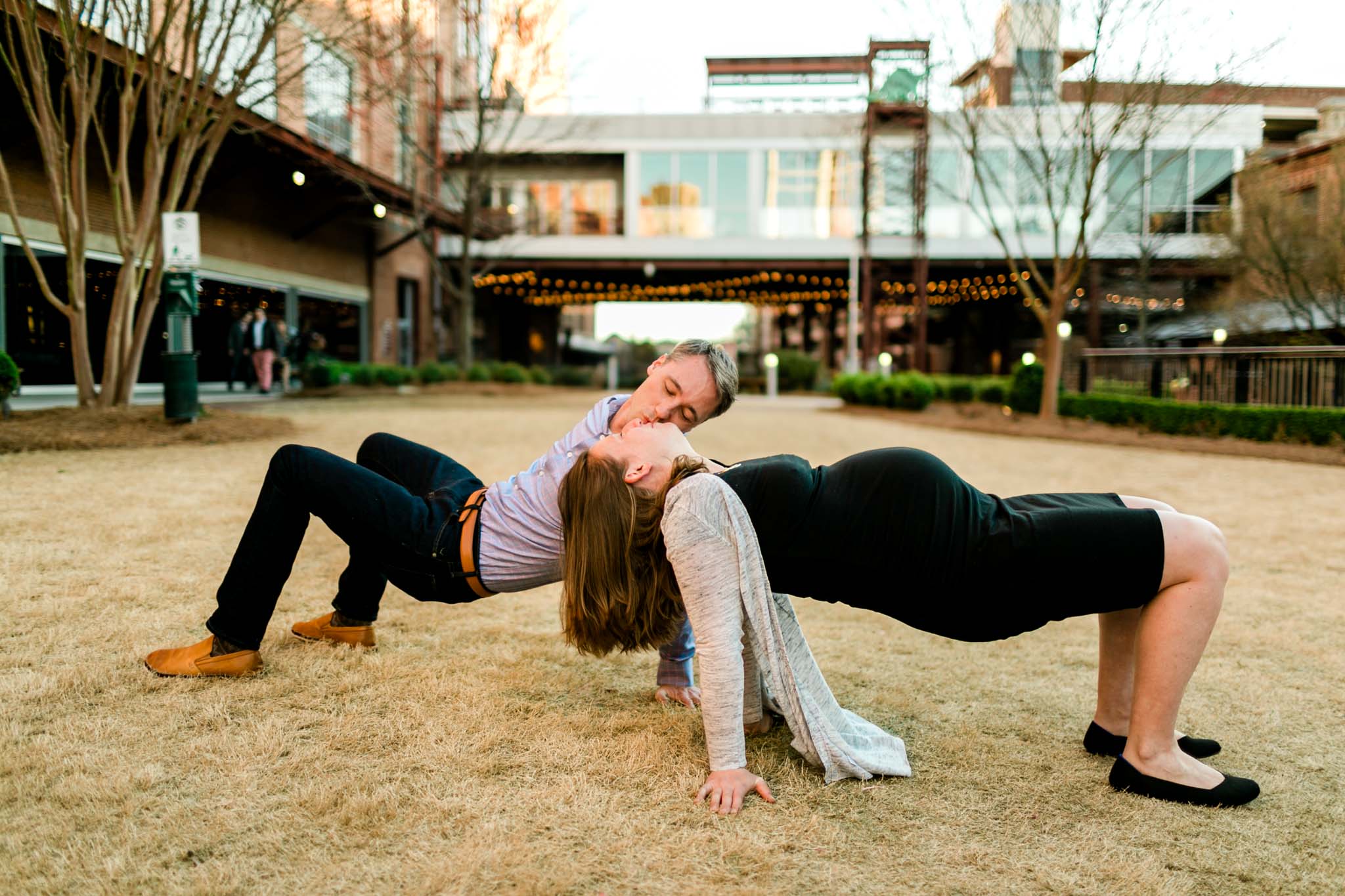 Couple kissing and doing yoga at American Tobacco Campus | Durham Newborn Photographer | By G. Lin Photography