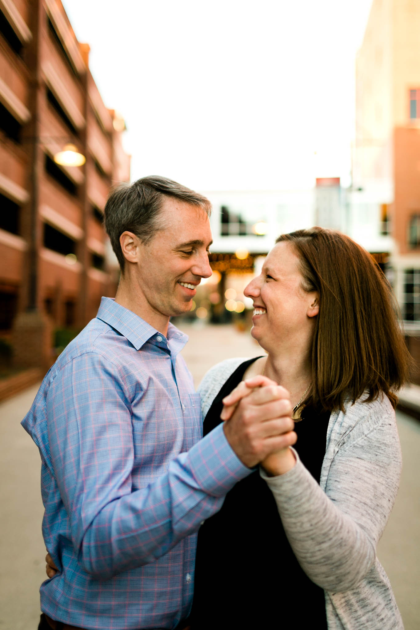 Couple smiling and dancing at American Tobacco Campus | Durham Family Photographer | By G. Lin Photography