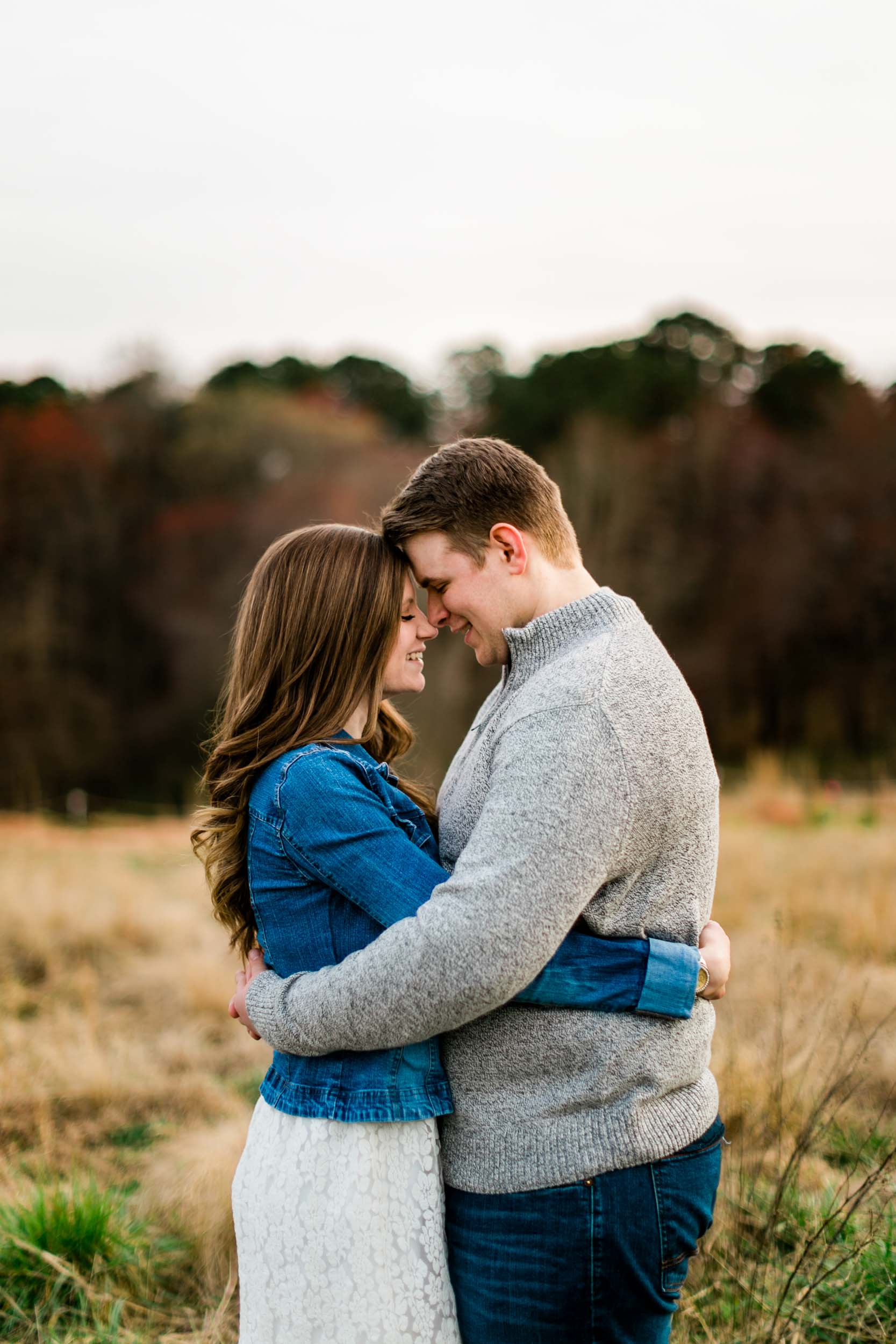 Couple embracing one another in field | Durham Wedding Photographer | By G. Lin Photography