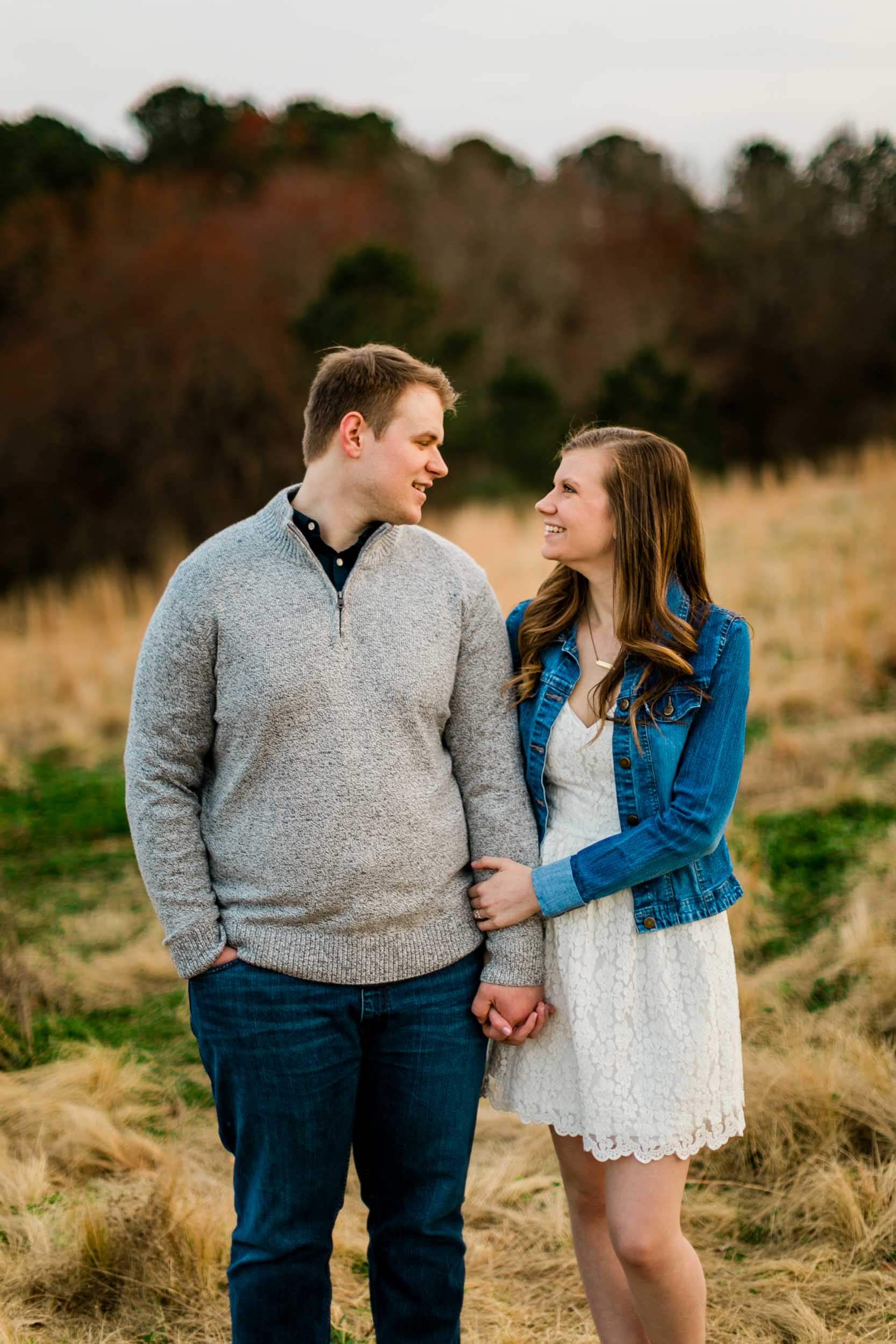 Couple looking at one another in open field | Durham Photographer | By G. Lin Photography