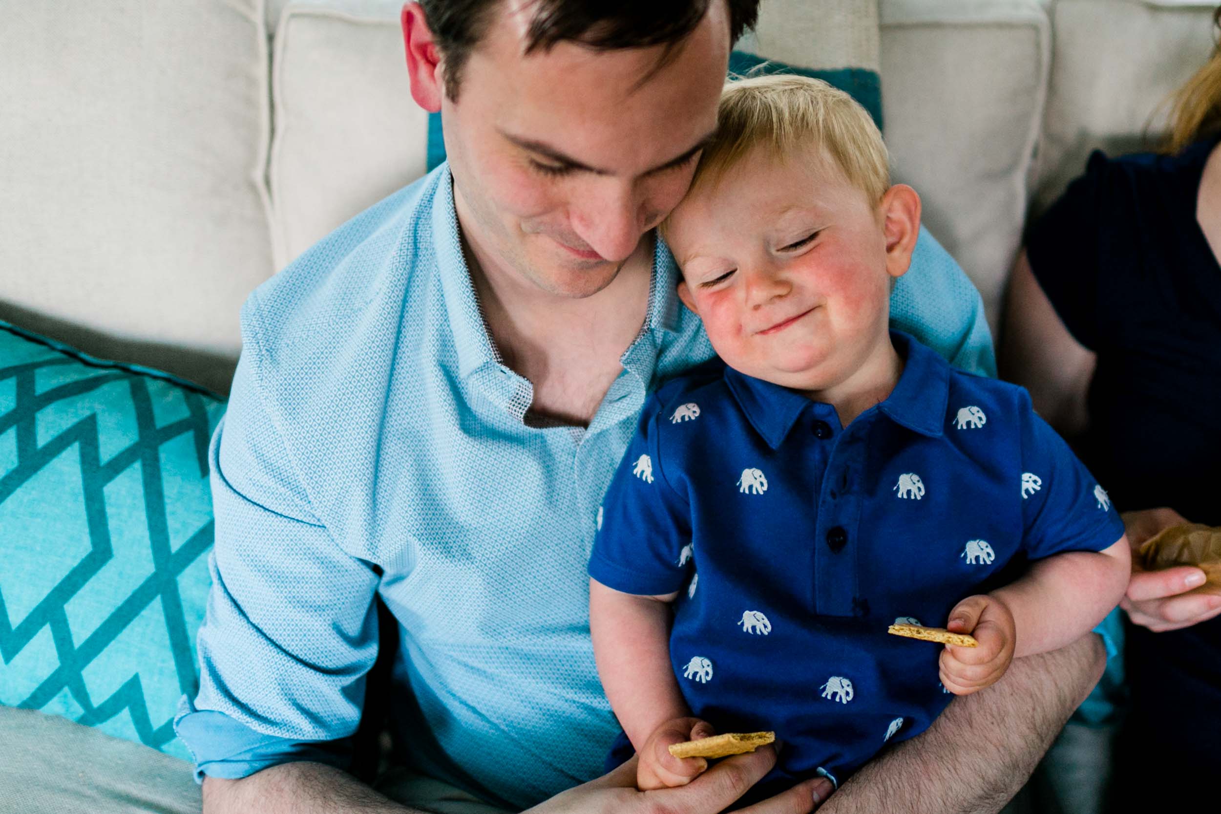 Dad holding son on lap | Raleigh Newborn Photographer | By G. Lin Photography