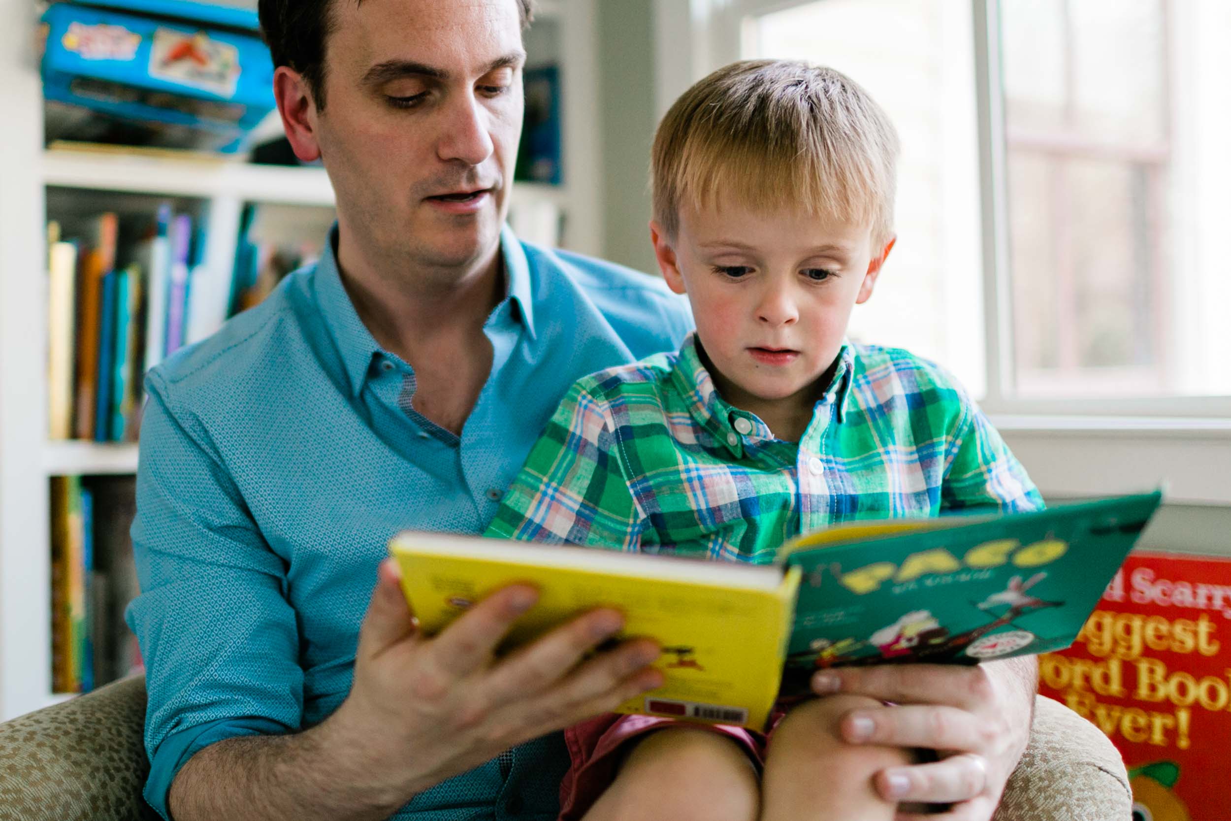 Father reading book with son on sofa | Raleigh Family Photographer | By G. Lin Photography