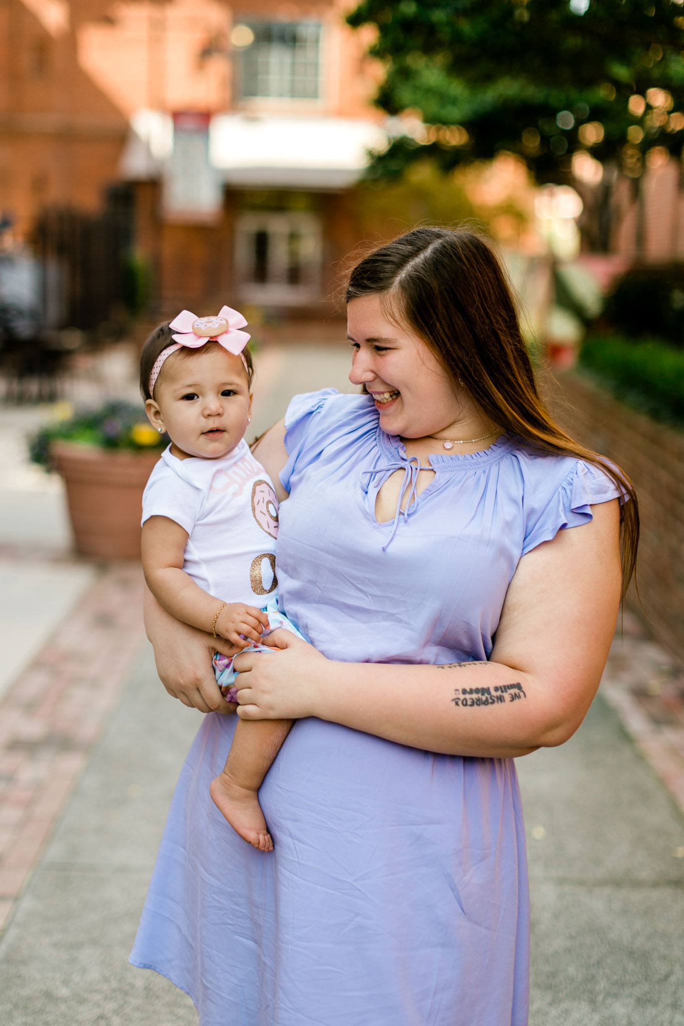 Mother holding and smiling at baby girl | Durham Family Photographer | By G. Lin Photography