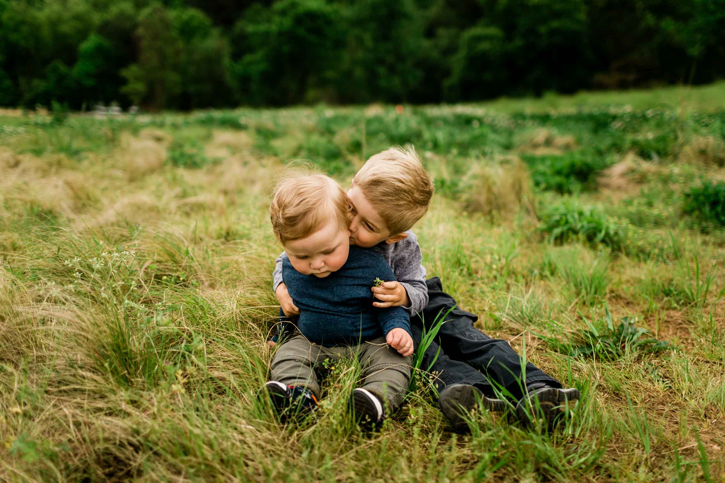 Cute photo of brothers sitting on the grass | Raleigh Family Photographer | By G. Lin Photography