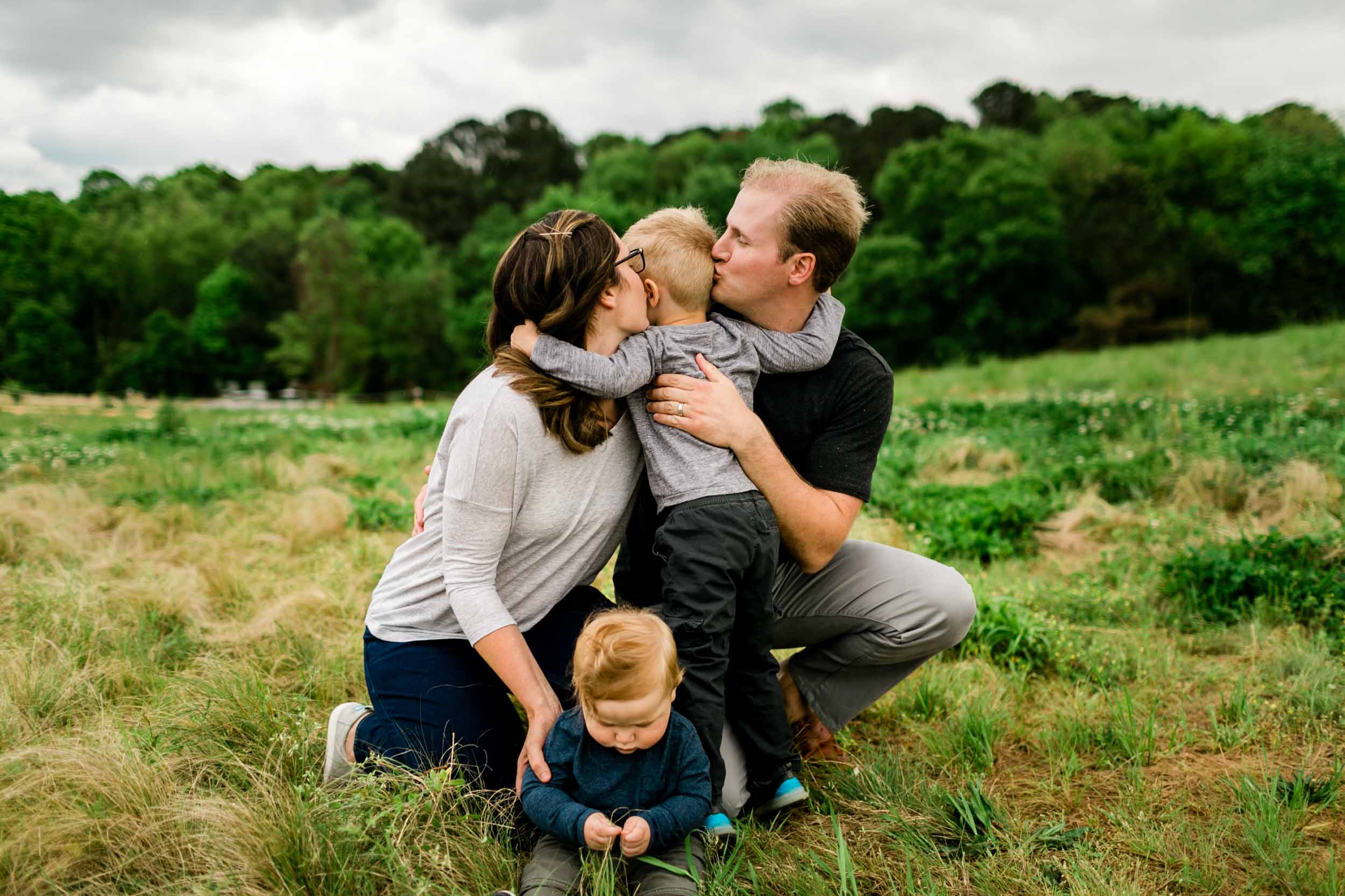 Parents kissing son on cheeks | Raleigh Family Photographer | By G. Lin Photography