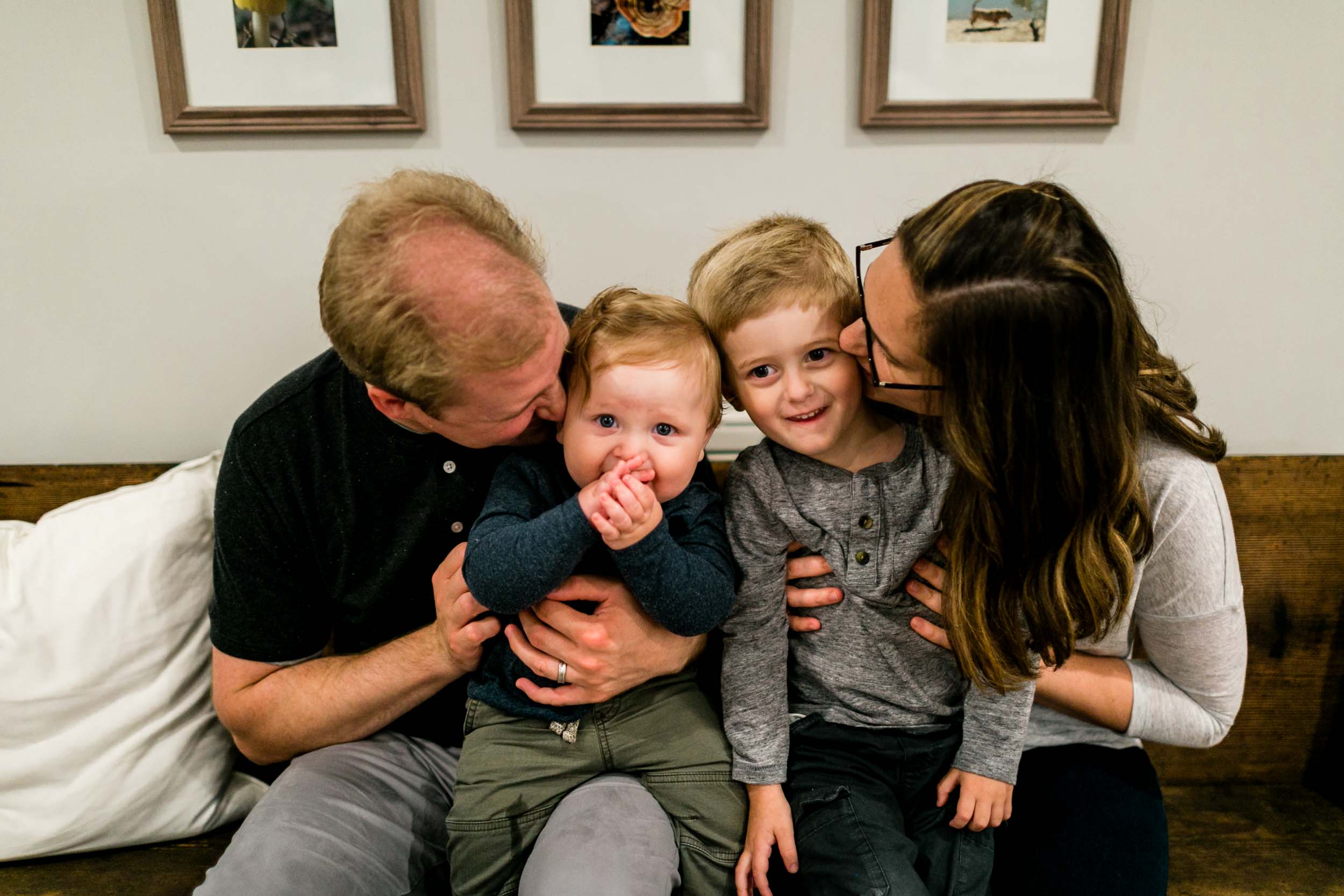 Parents kissing children on cheeks | Raleigh Family Photographer | By G. Lin Photography