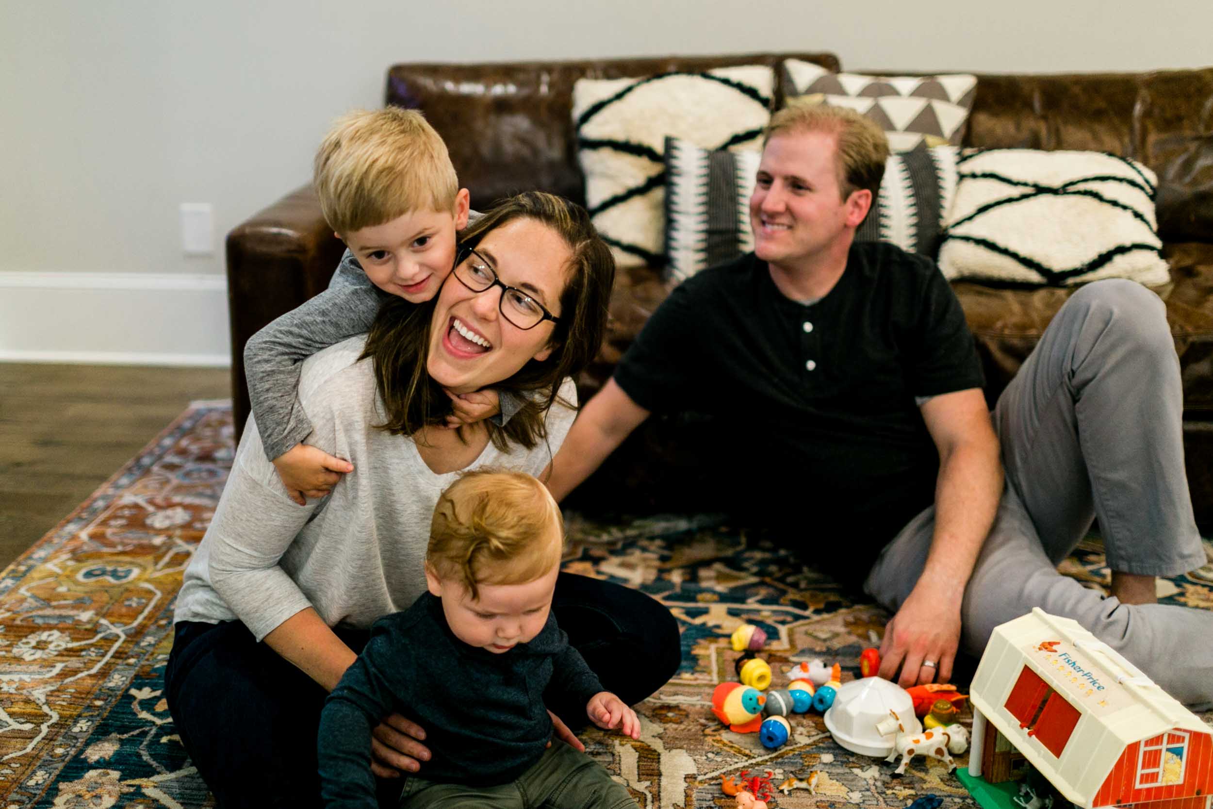 Candid family photo with son holding mom | Raleigh Family Photographer | By G. Lin Photography