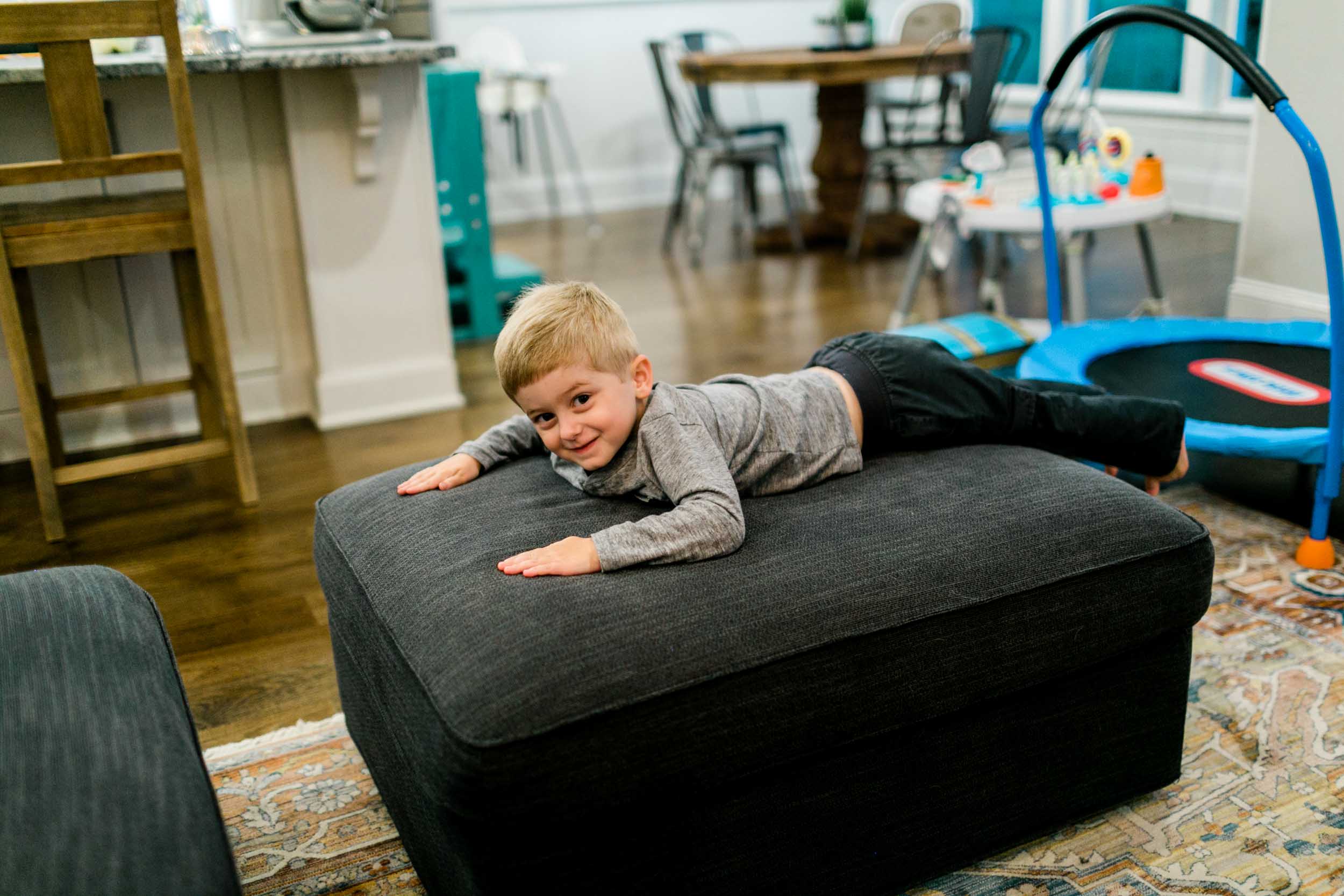 Boy smiling from couch | Durham Photographer | By G. Lin Photography