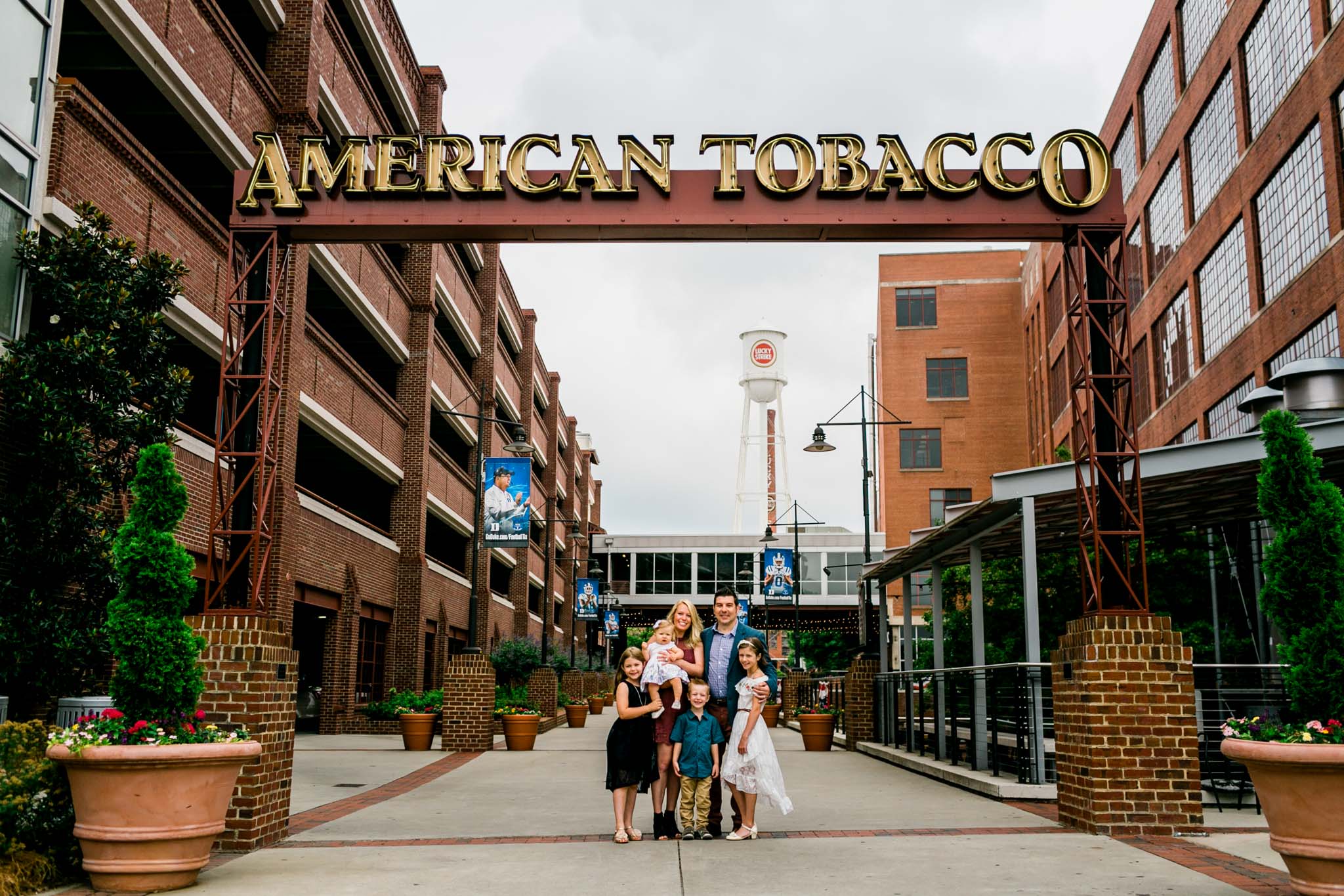 Durham Family Photographer | By G. Lin Photography | Family portrait next to American Tobacco Campus sign