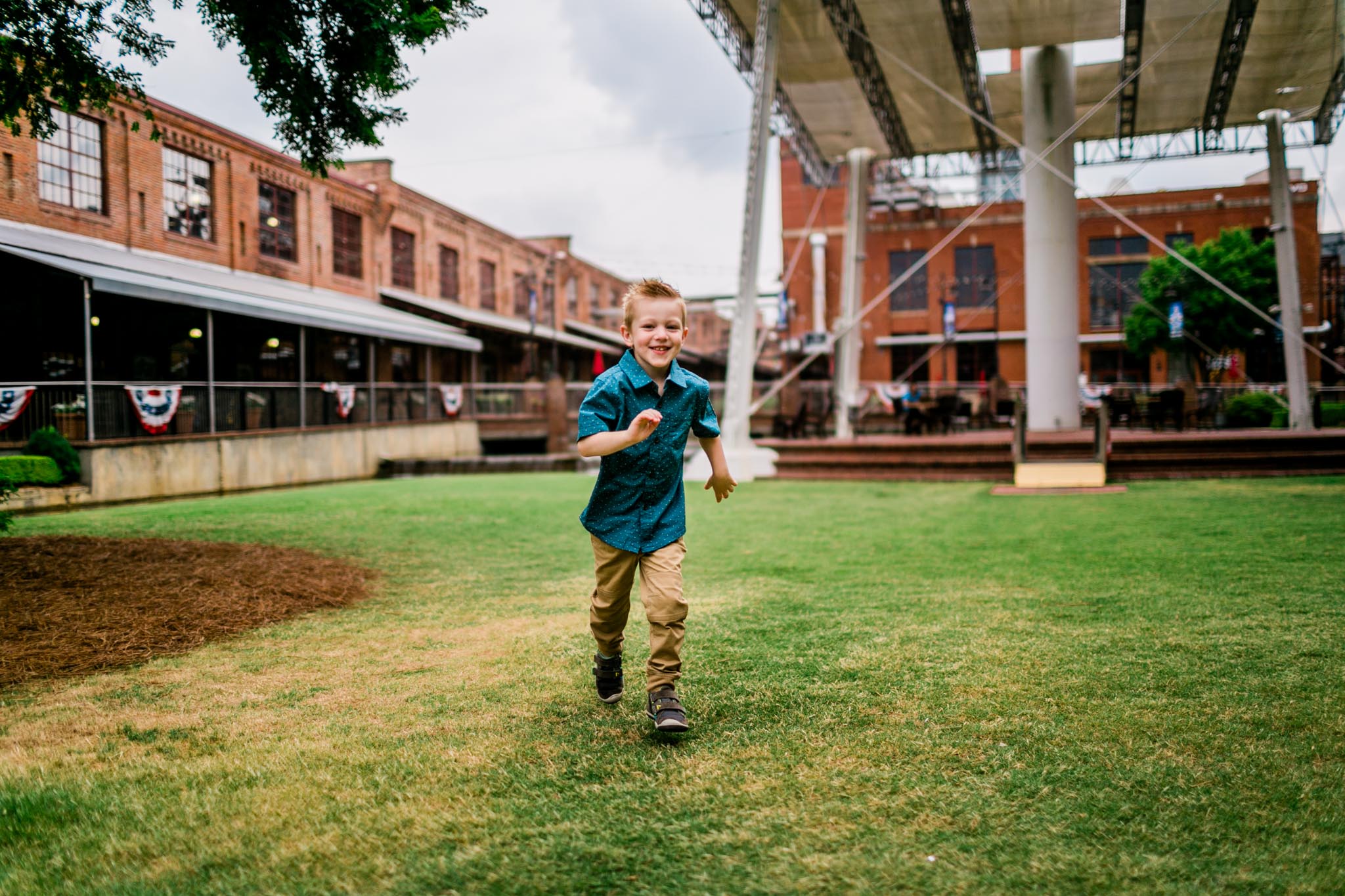 Durham Family Photographer | By G. Lin Photography | Candid photo of young boy running across grass