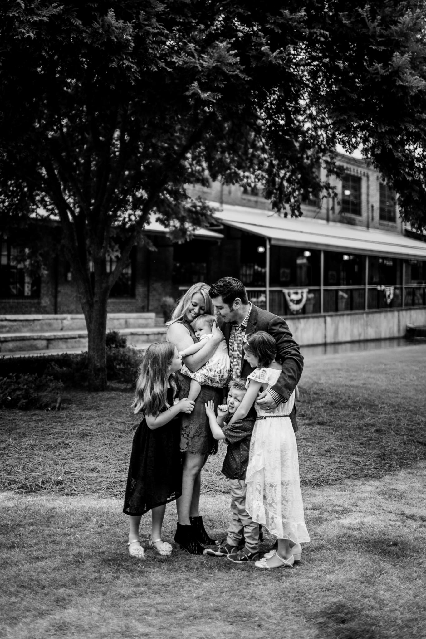 Durham Family Photographer | By G. Lin Photography | Candid black and white portrait of family hugging together