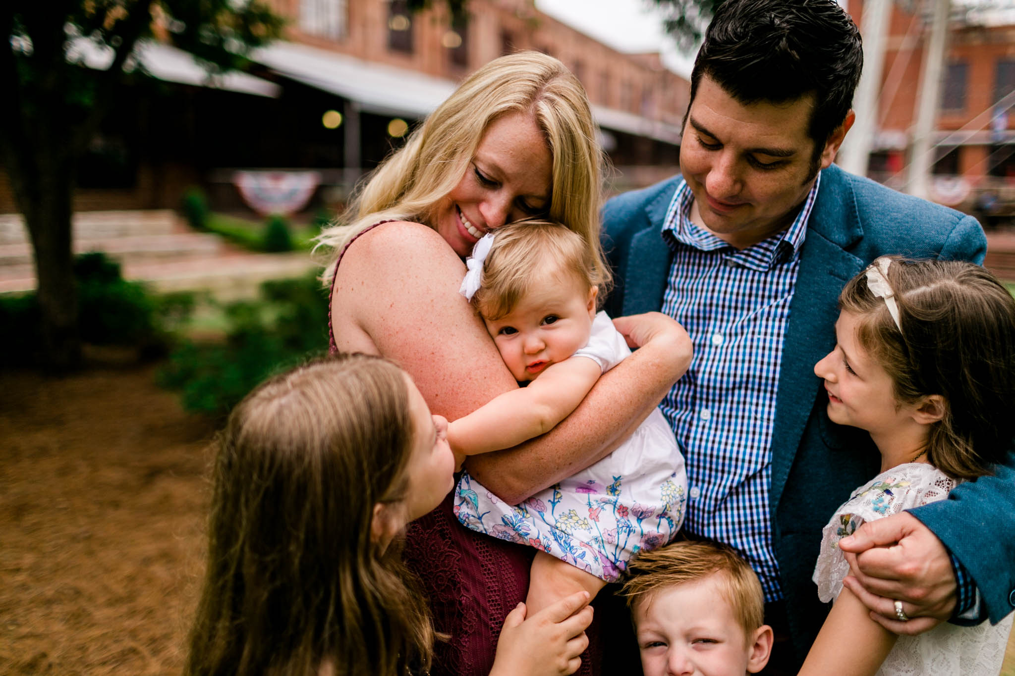 Durham Family Photographer | By G. Lin Photography | Organic Lifestyle family photo outside with mom snuggling baby