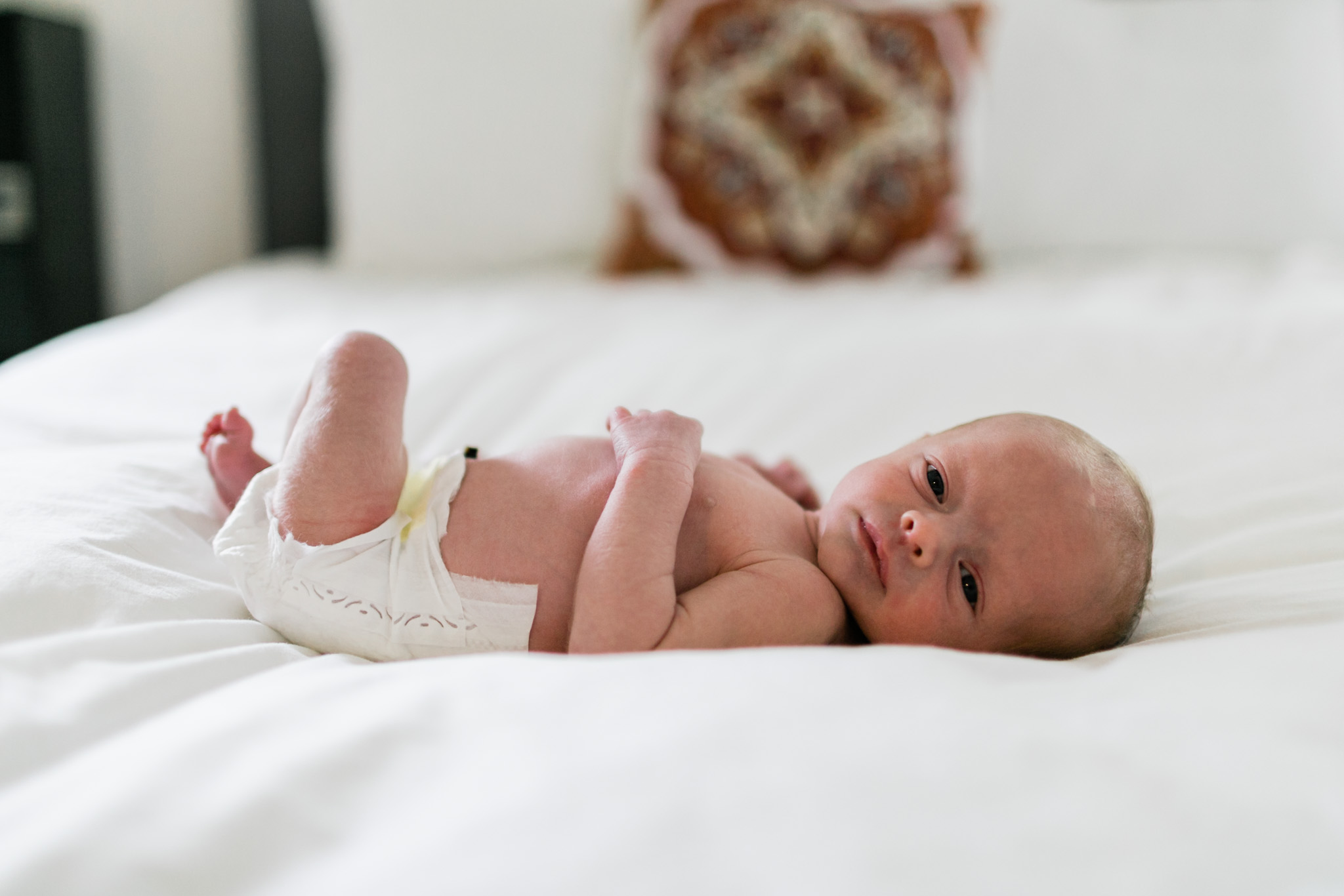 Durham Newborn Photographer | By G. Lin Photography | Organic newborn baby photo on bed with white sheets