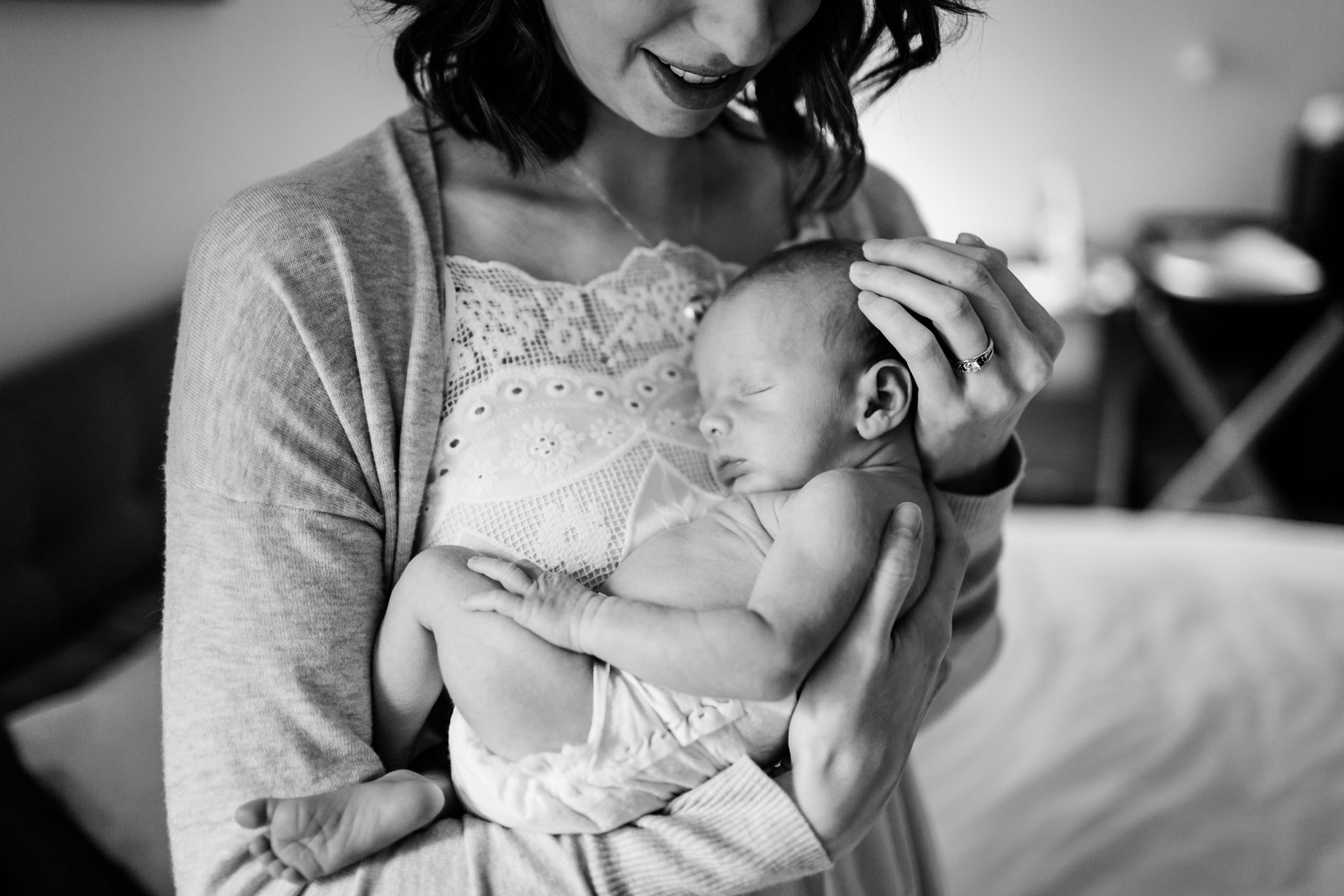 Durham Newborn Photographer | By G. Lin Photography | Black and white photo of mother holding baby against her