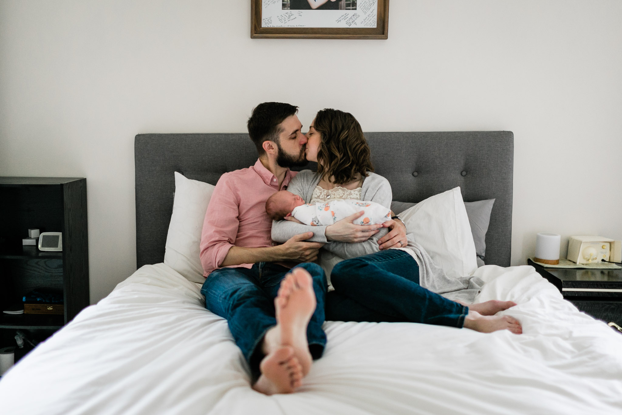 Durham Newborn Photographer | By G. Lin Photography | Parents sharing a kiss during newborn photo shoot
