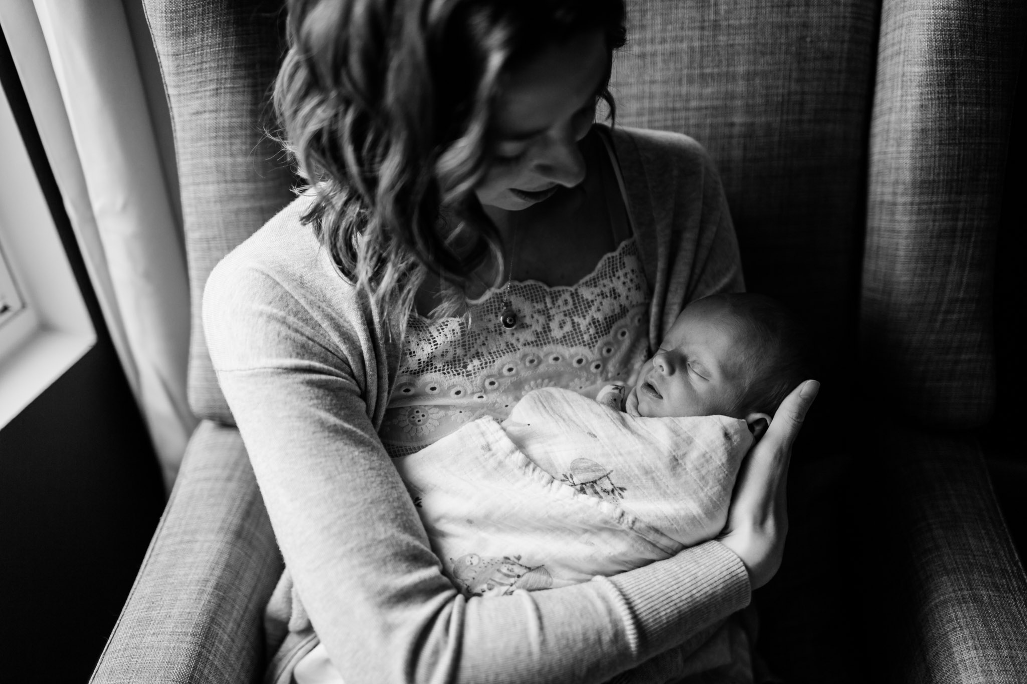 Durham Newborn Photographer | By G. Lin Photography | Black and white portrait of mother holding baby in her arms