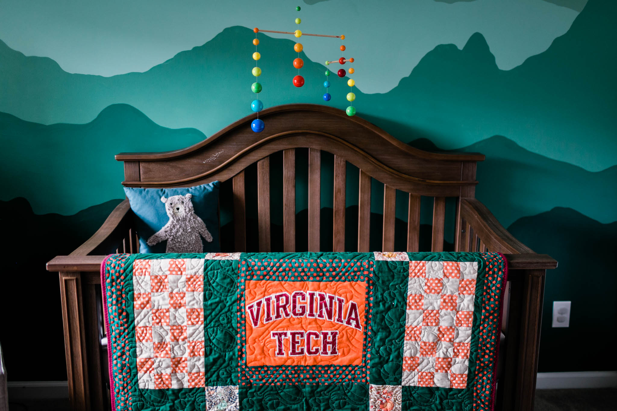 Durham Newborn Photographer | By G. Lin Photography | Crib with virginia tech quilt hanging on it