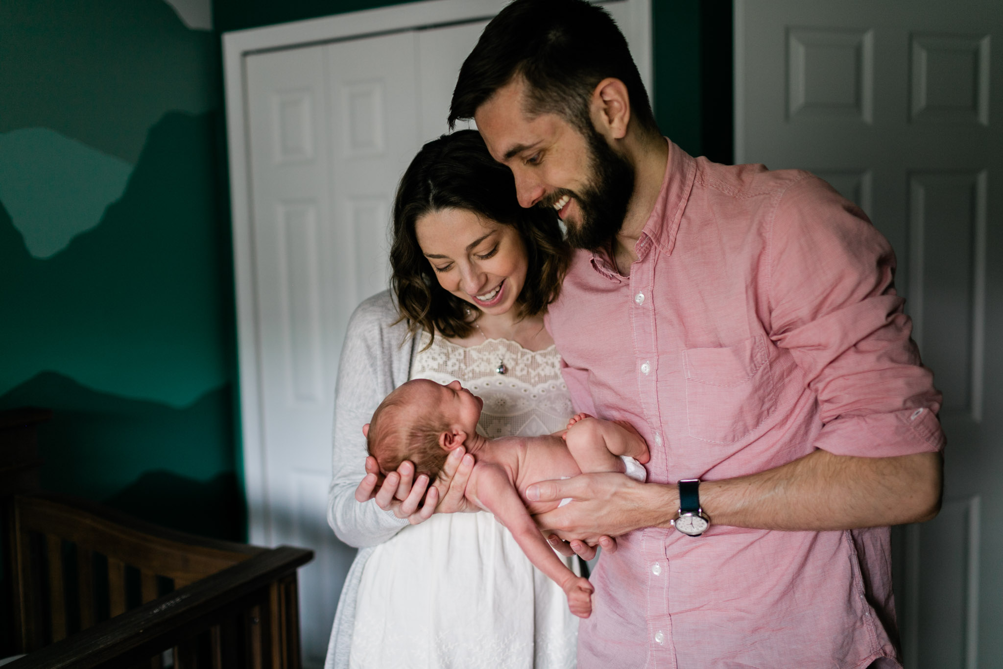 Durham Newborn Photographer | By G. Lin Photography | New parents holding baby and laughing