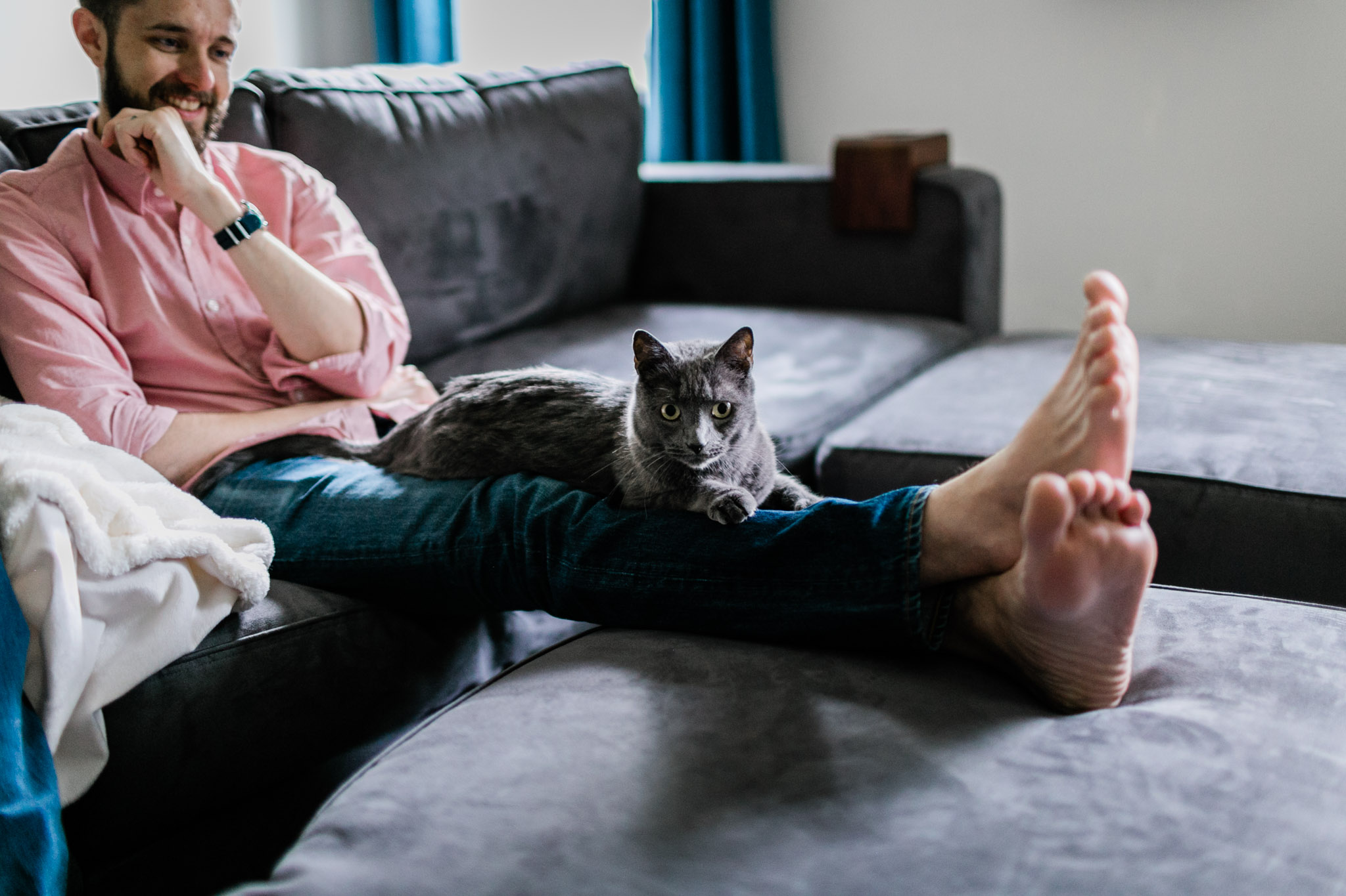 Durham Newborn Photographer | By G. Lin Photography | Cat sitting on man's legs and looking at camera