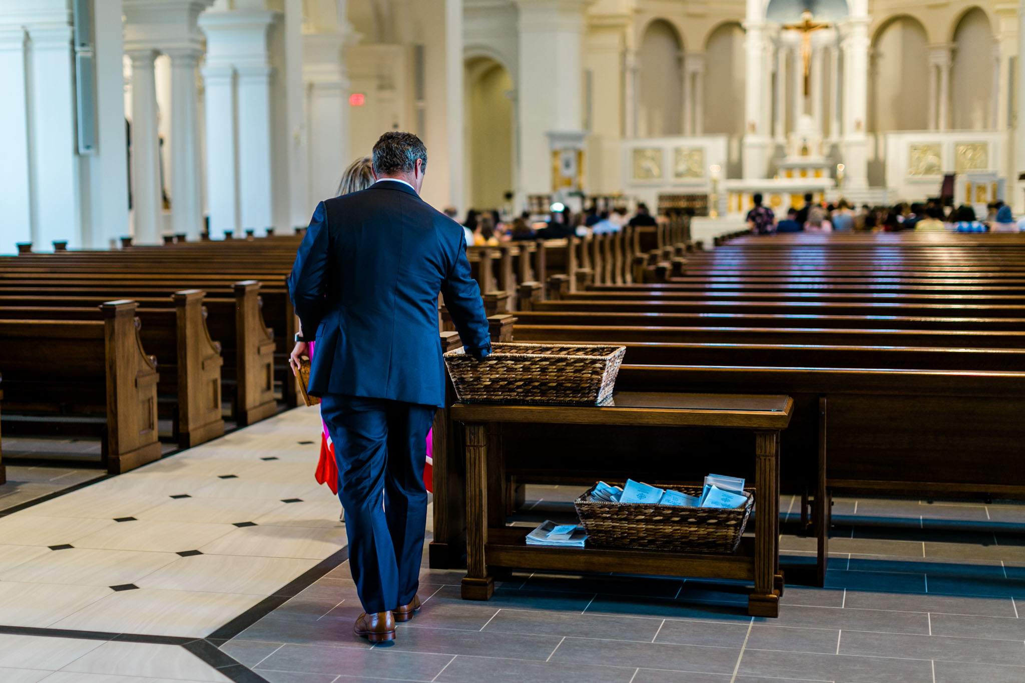 Man picking up wedding program |  Raleigh Wedding Photographer | By G. Lin Photography