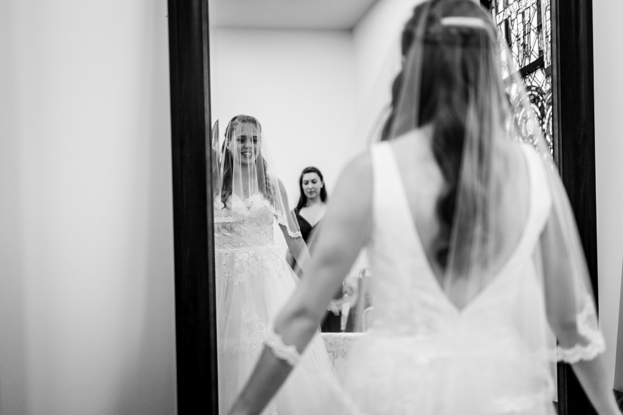 Beautiful black and white photo of bride looking at mirror | Raleigh Wedding Photographer | By G. Lin Photography