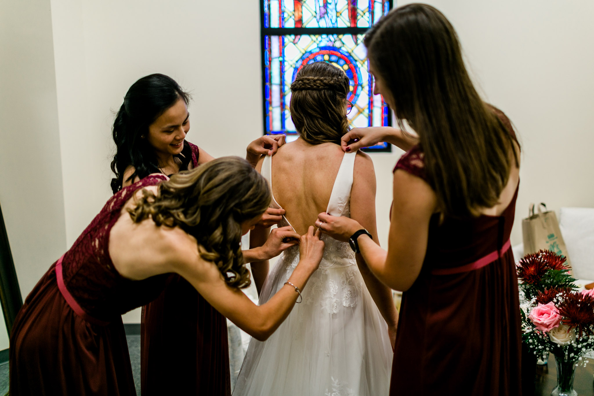 Bridesmaids helping bride with dress | Durham Wedding Photographer | By G. Lin Photography