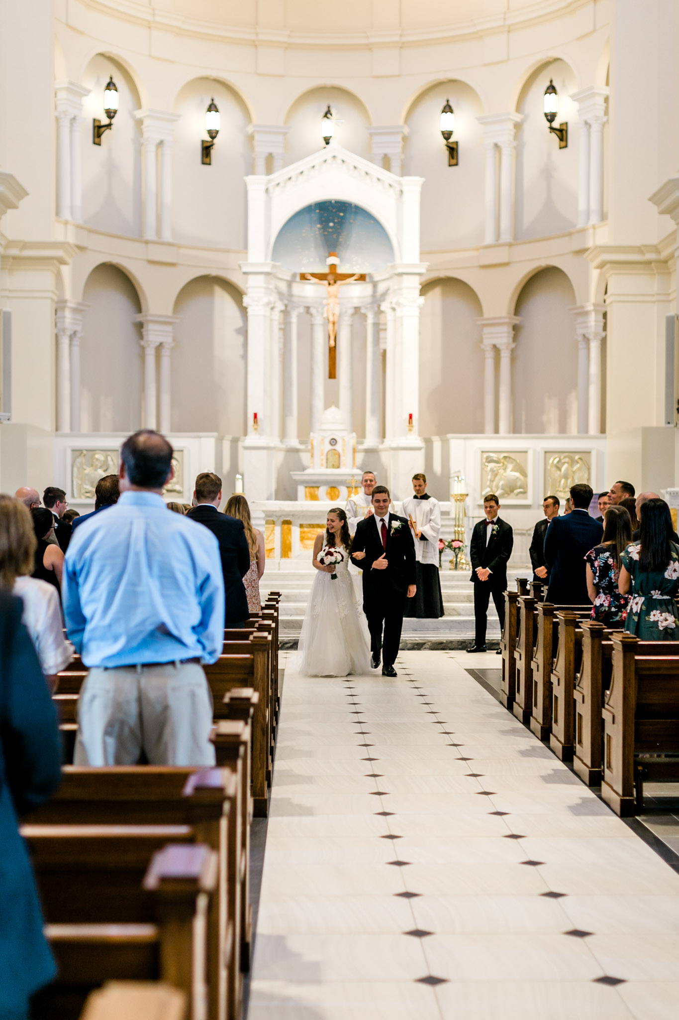 Bride and groom walking down the aisle | Holy Name of Jesus Cathedral | Raleigh Wedding Photographer | By G. Lin Photography