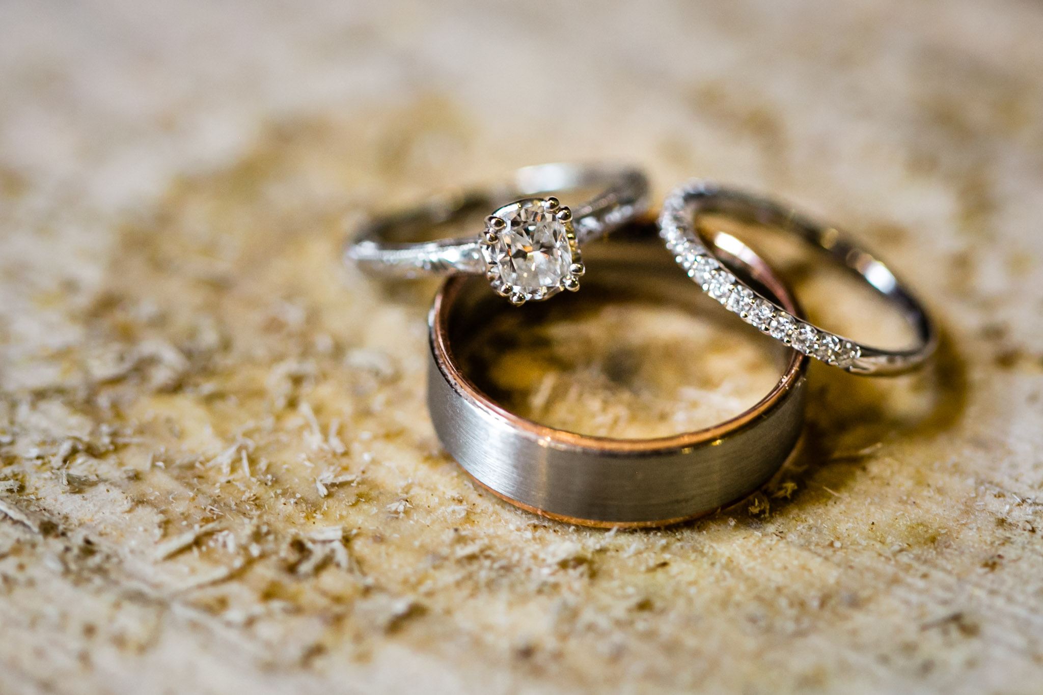 Wedding bands sitting on piece of wood | Durham Wedding Photographer | By G. Lin Photography