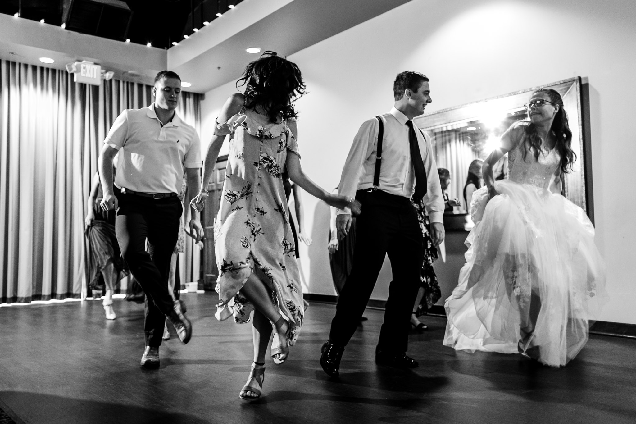 Black and white photo of people dancing at wedding reception at Royal Banquet Conference Center | Raleigh Wedding Photographer | By G. Lin Photography