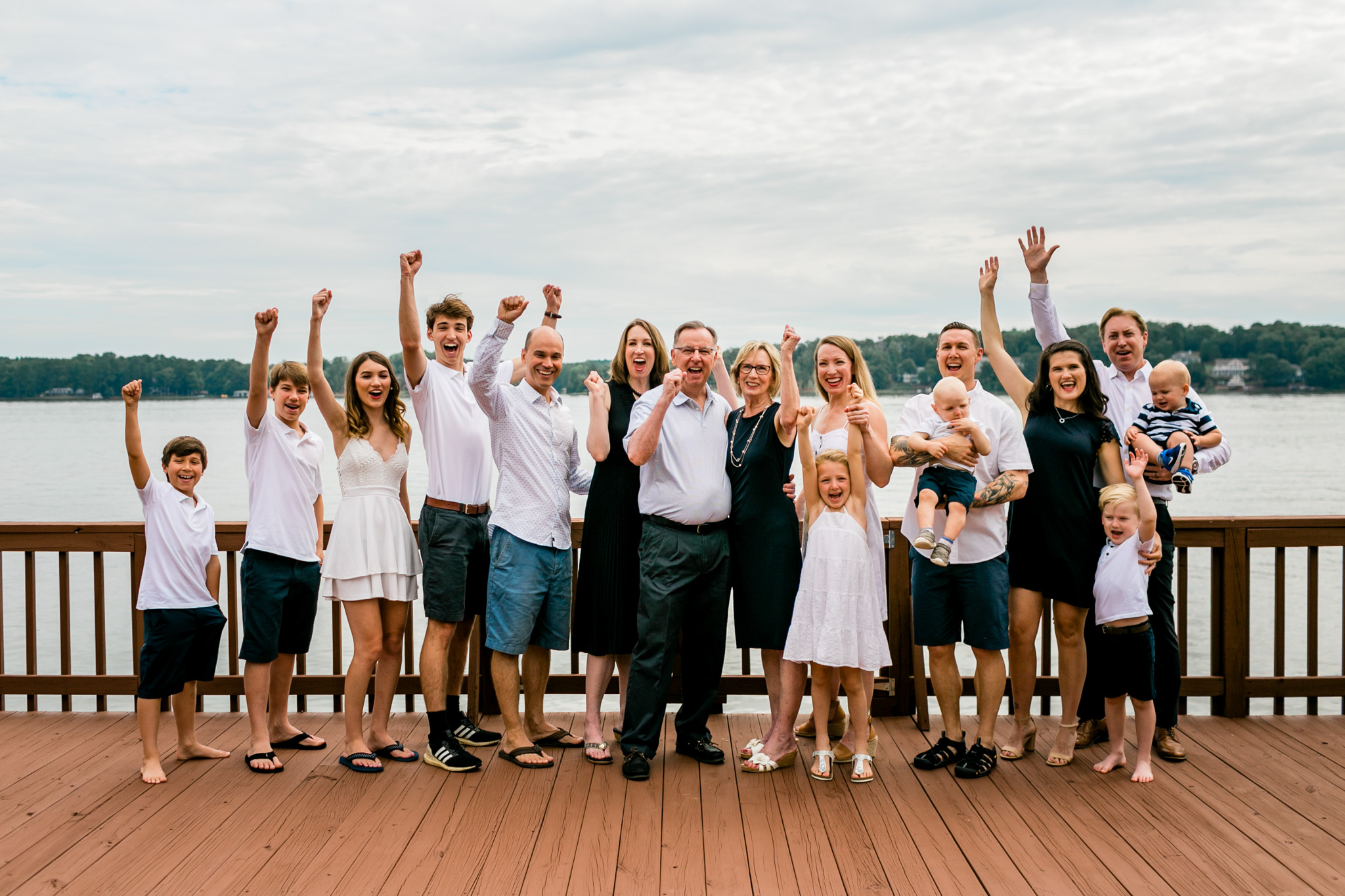 Group family portrait on dock at Lake Gaston cheering | Durham Family Photographer | By G. Lin Photography