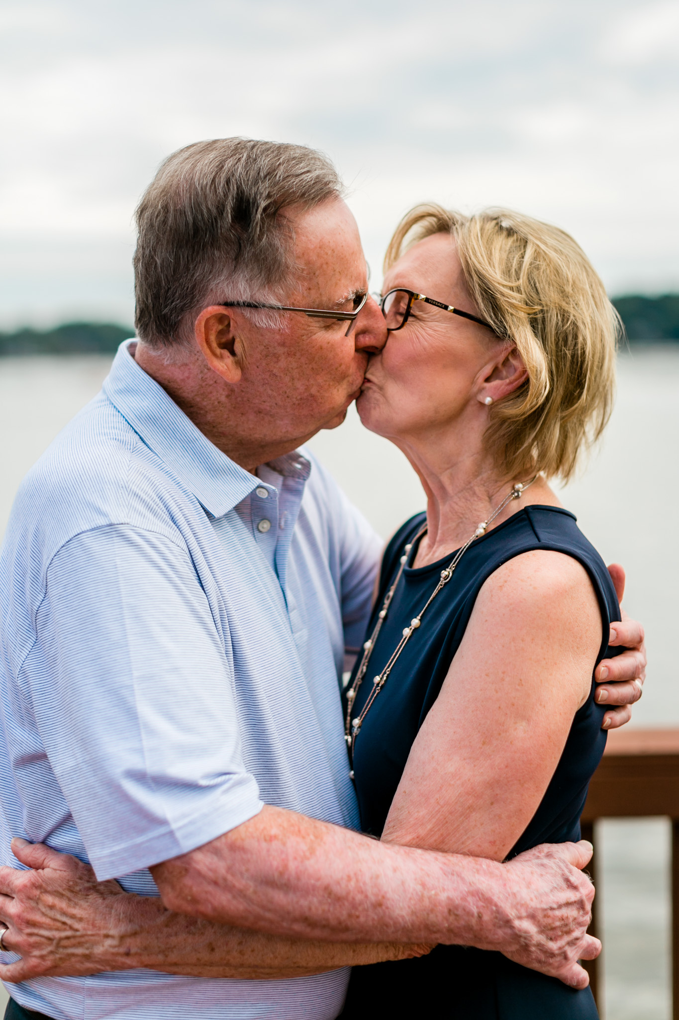 50th wedding anniversary of couple kissing | Raleigh Family Photographer | By G. Lin Photography