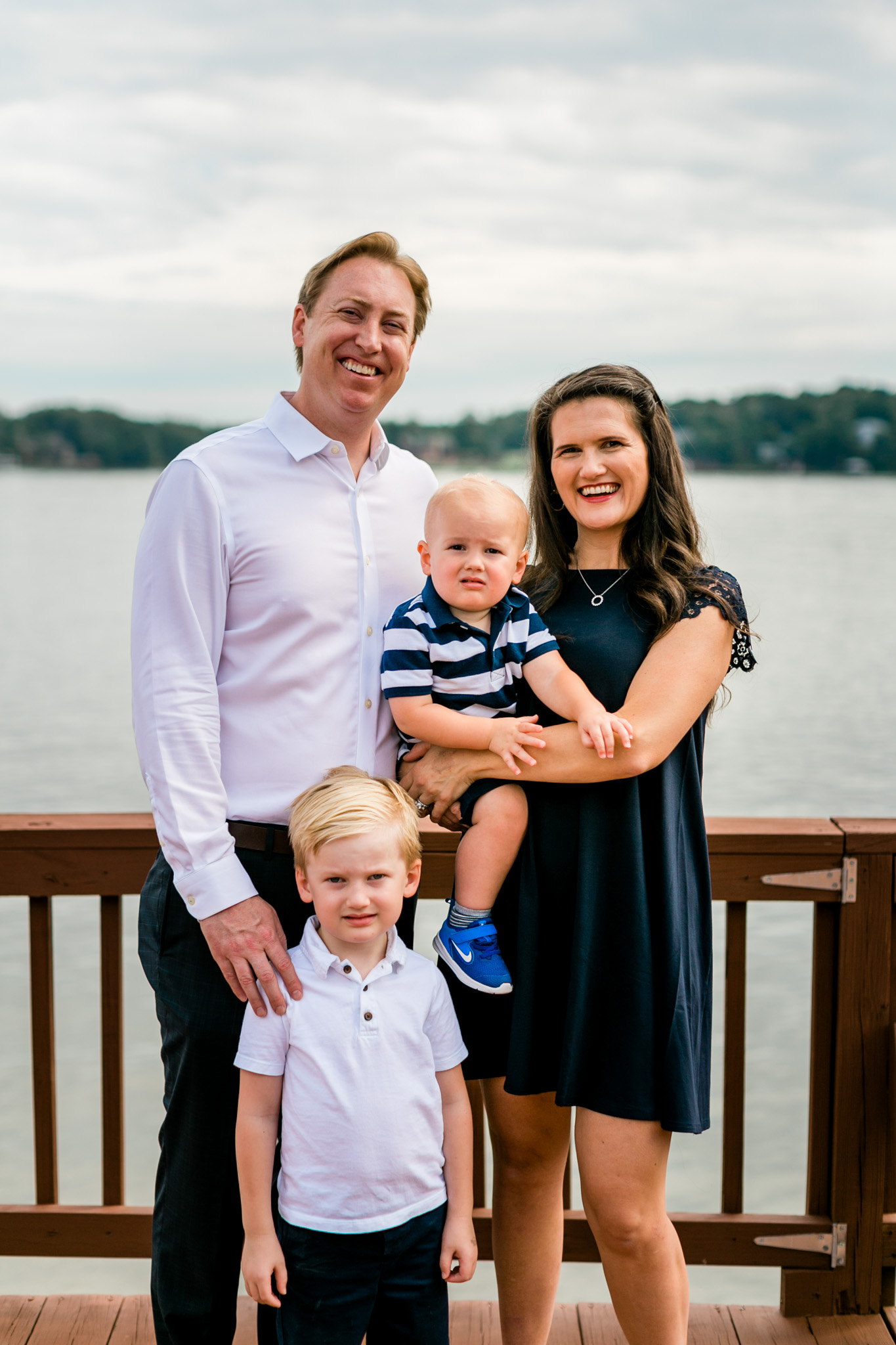 Raleigh Family Photographer | By G. Lin Photography | Family of four standing on dock Lake Gaston