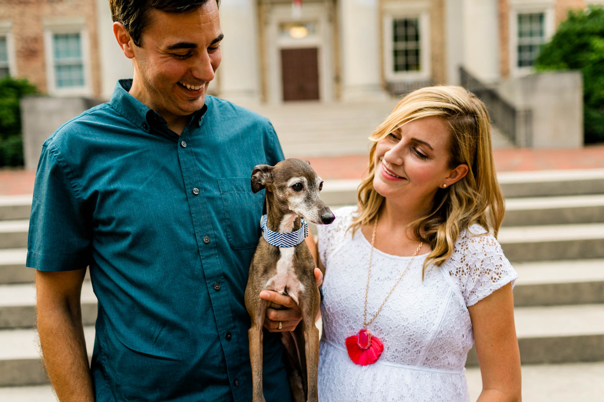 Chapel Hill Maternity Photographer at UNC | By G. Lin Photography | Couple holding dog in front of South Building
