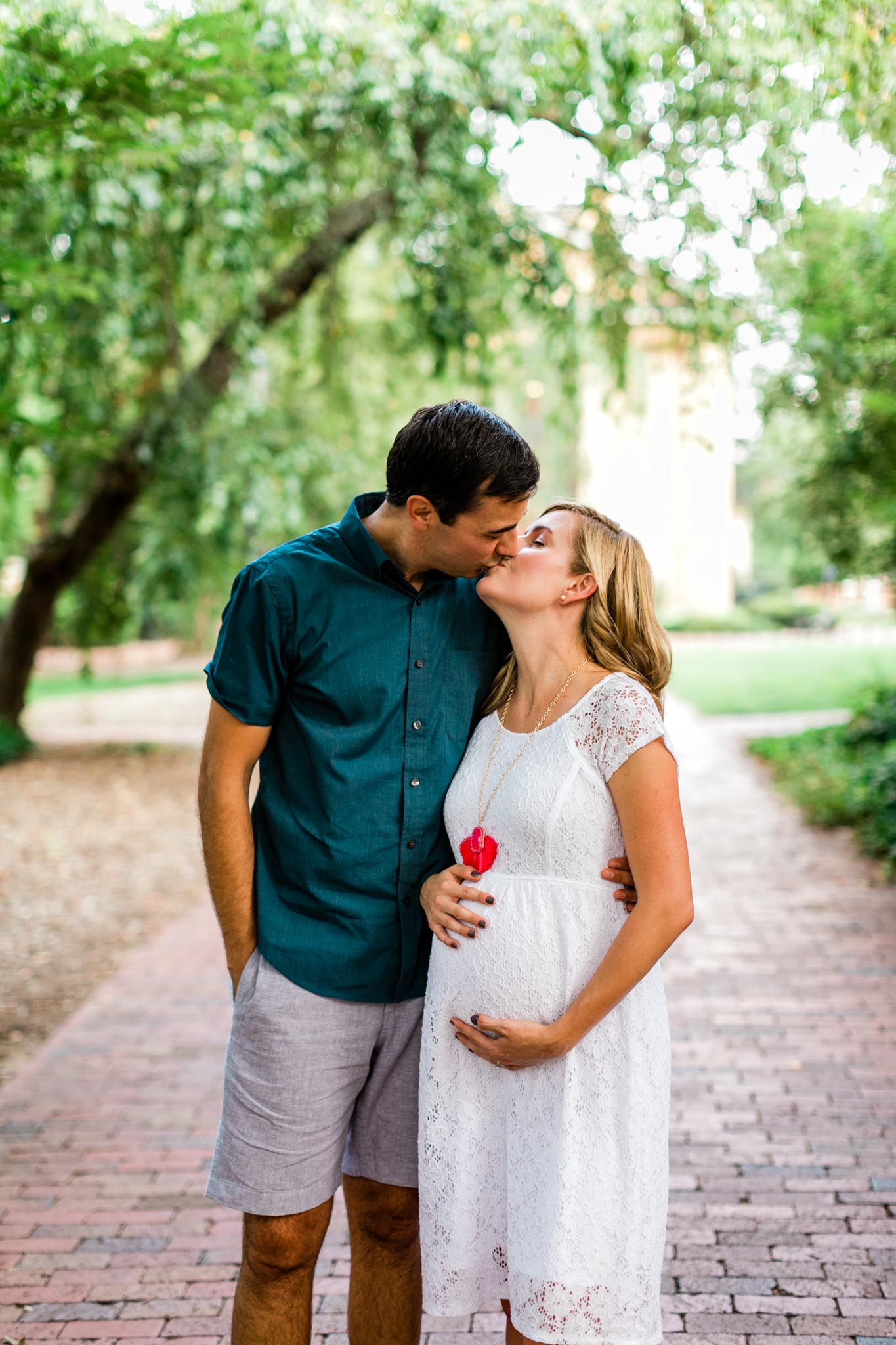 Couple kissing at McCorkle Place UNC | Chapel Hill Maternity Photographer | By G. Lin Photography