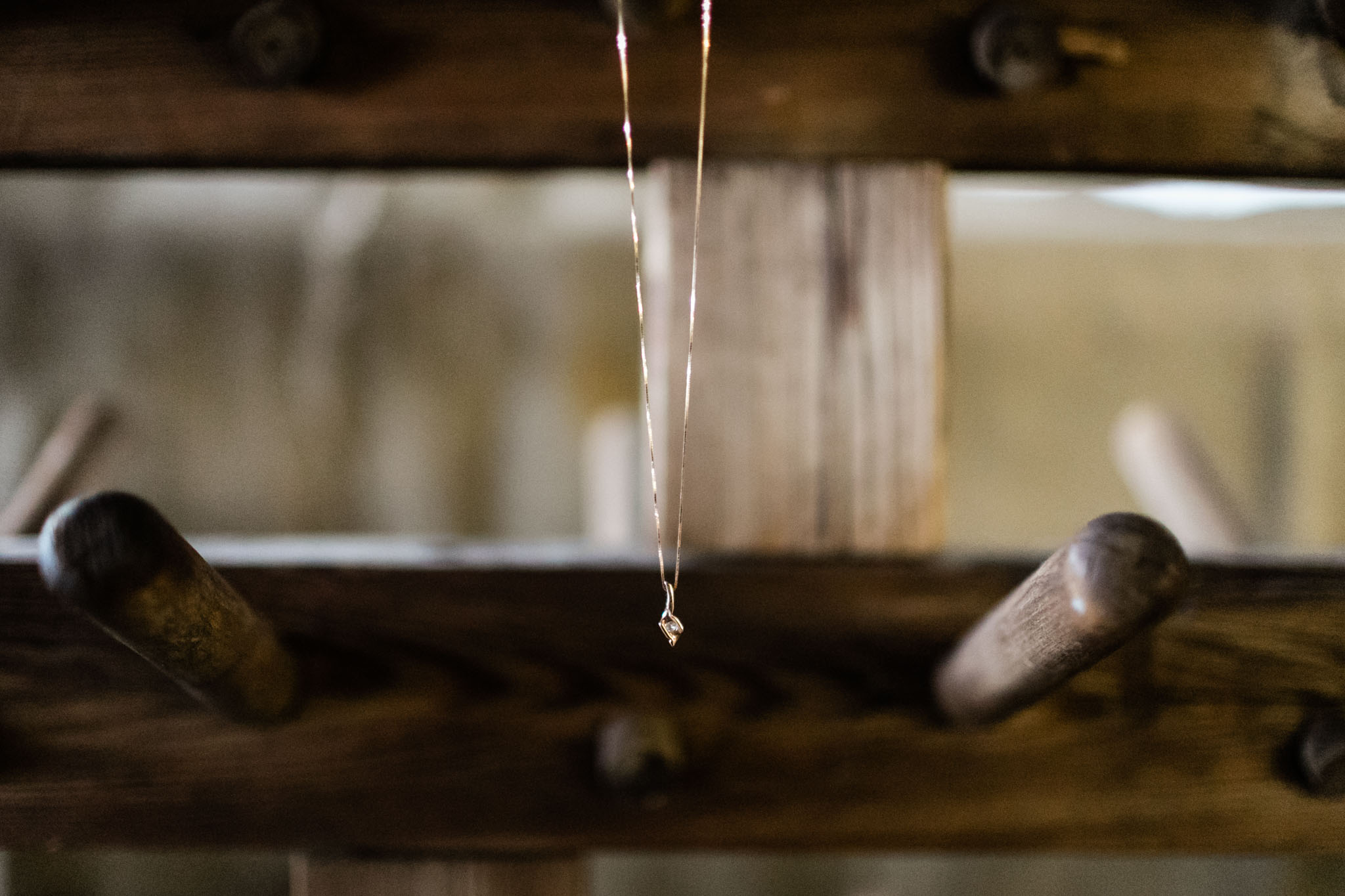 Haw River Ballroom Wedding | Durham Photographer | By G. Lin Photography | Gold necklace hanging on wooden peg