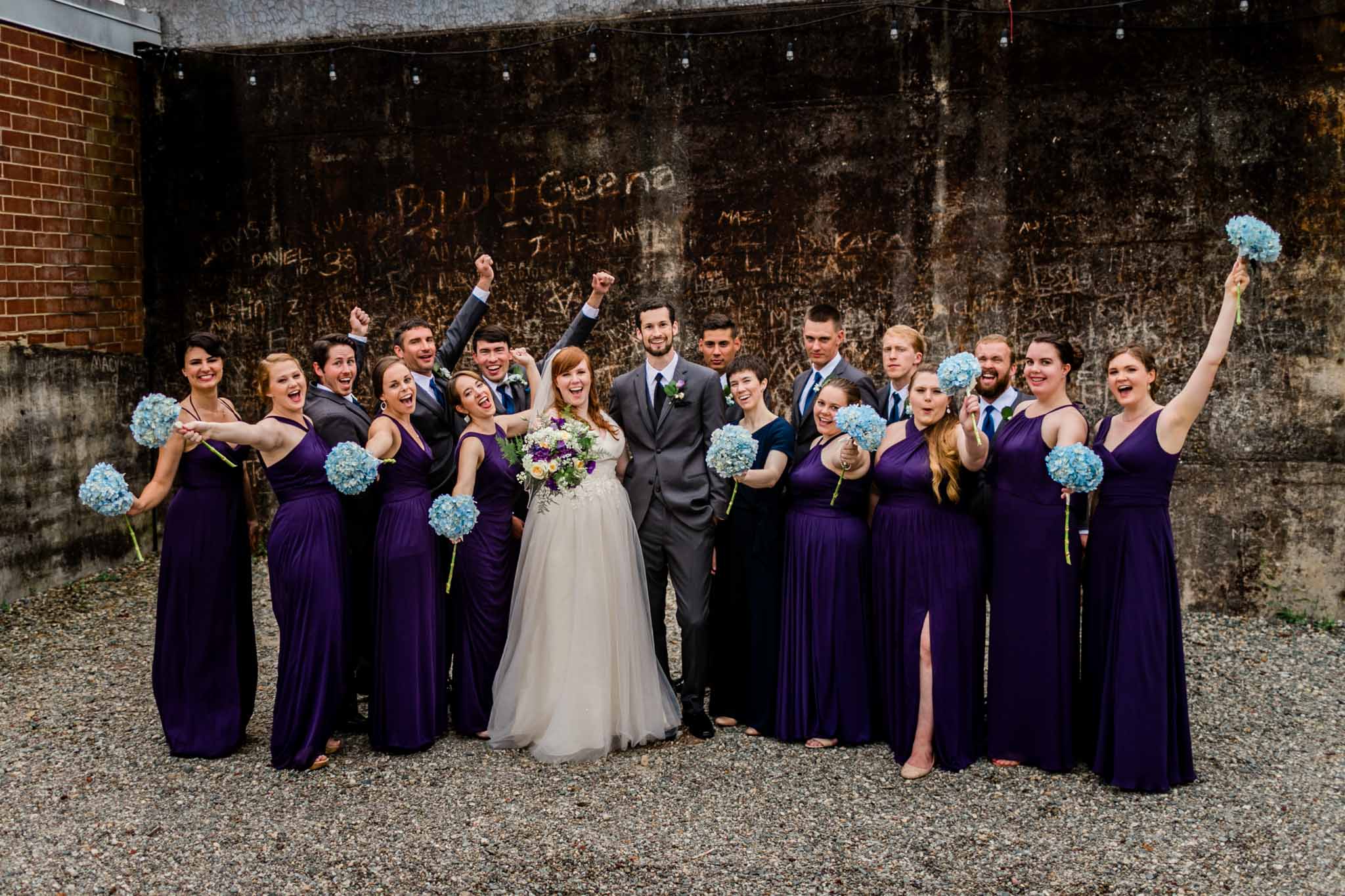 Haw River Ballroom Wedding | Durham Photographer | By G. Lin Photography | Wedding party outside of amphitheater cheering
