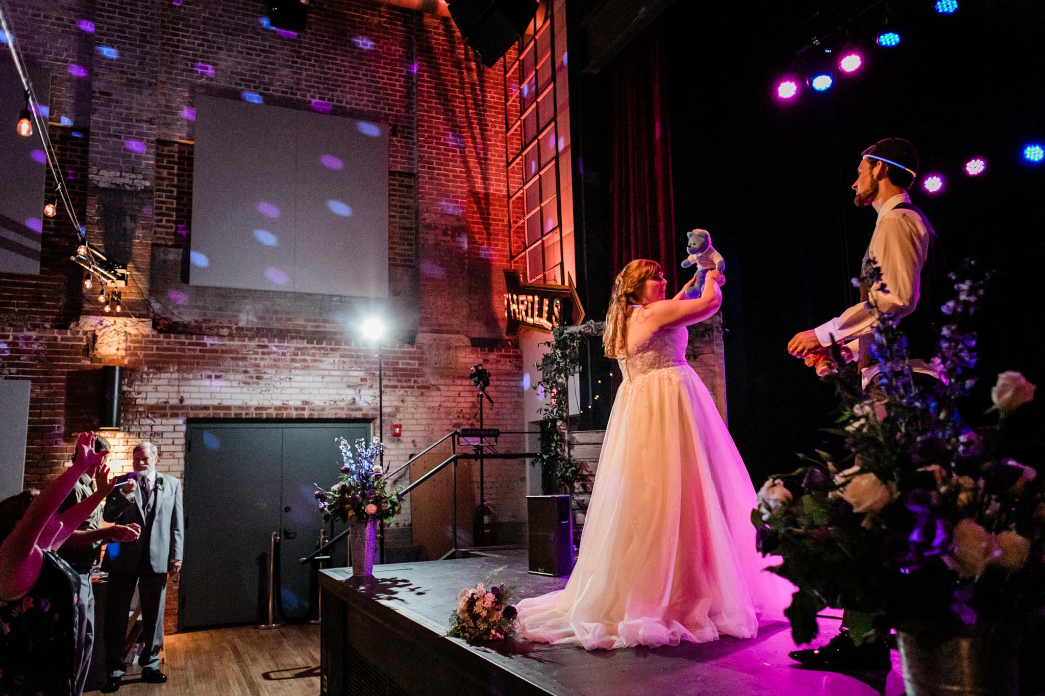 Haw River Ballroom Wedding | Durham Photographer | By G. Lin Photography | Bride tossing bear towards crowd