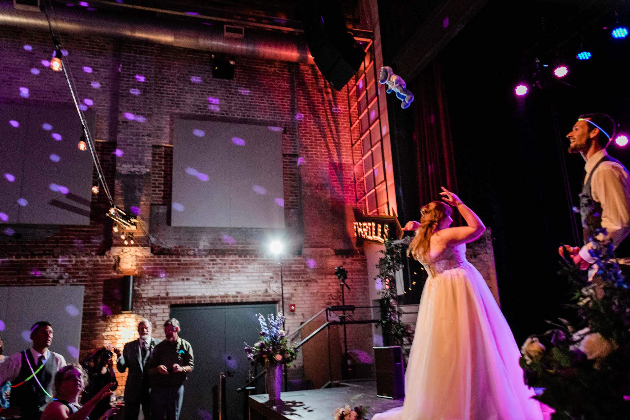 Haw River Ballroom Wedding | Durham Photographer | By G. Lin Photography | Bride tossing bear towards crowd