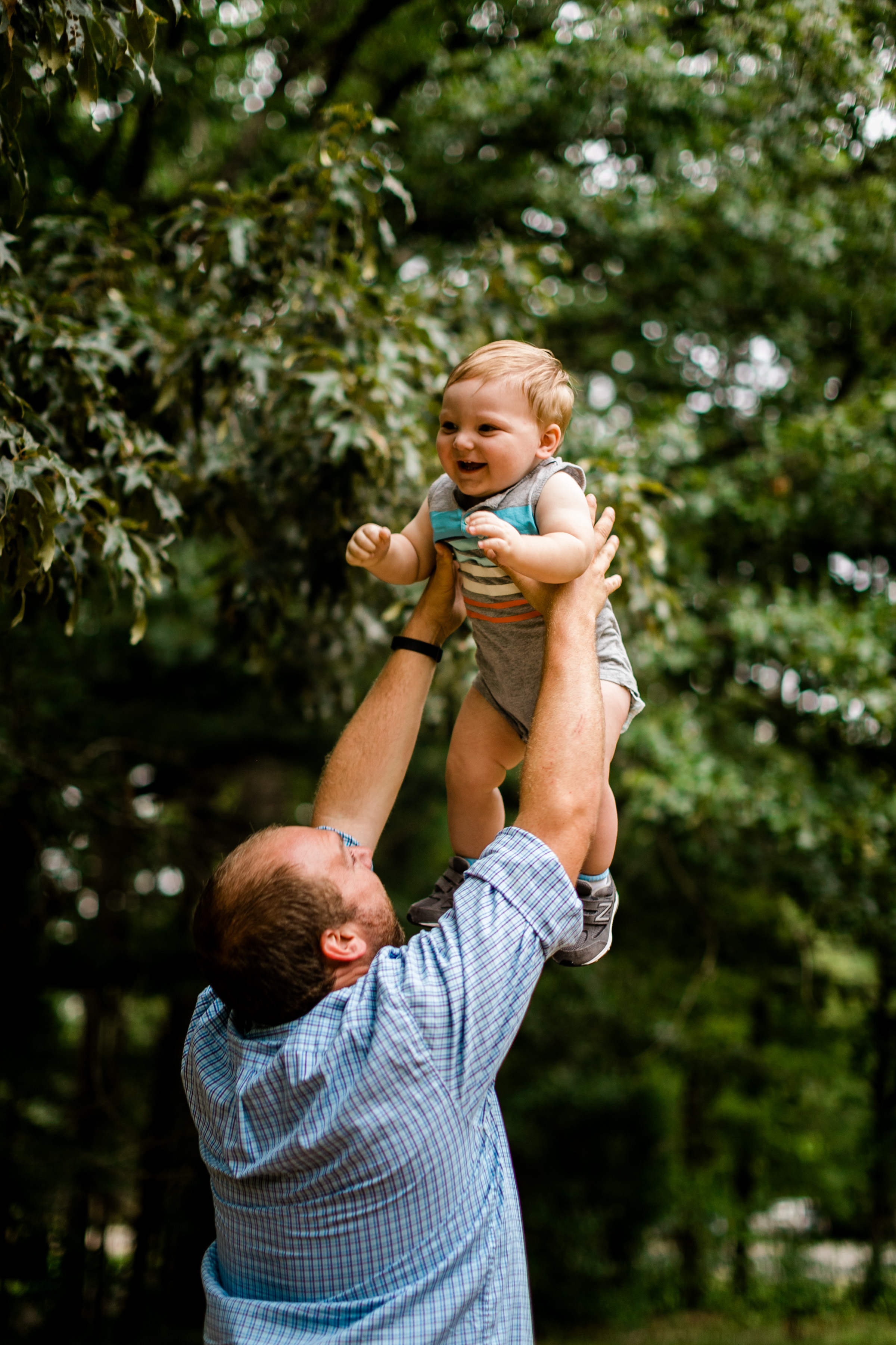 Durham Family Photographer | By G. Lin Photography | Outdoor portraits at Spruce Pine Lodge | Dad throwing son in the air