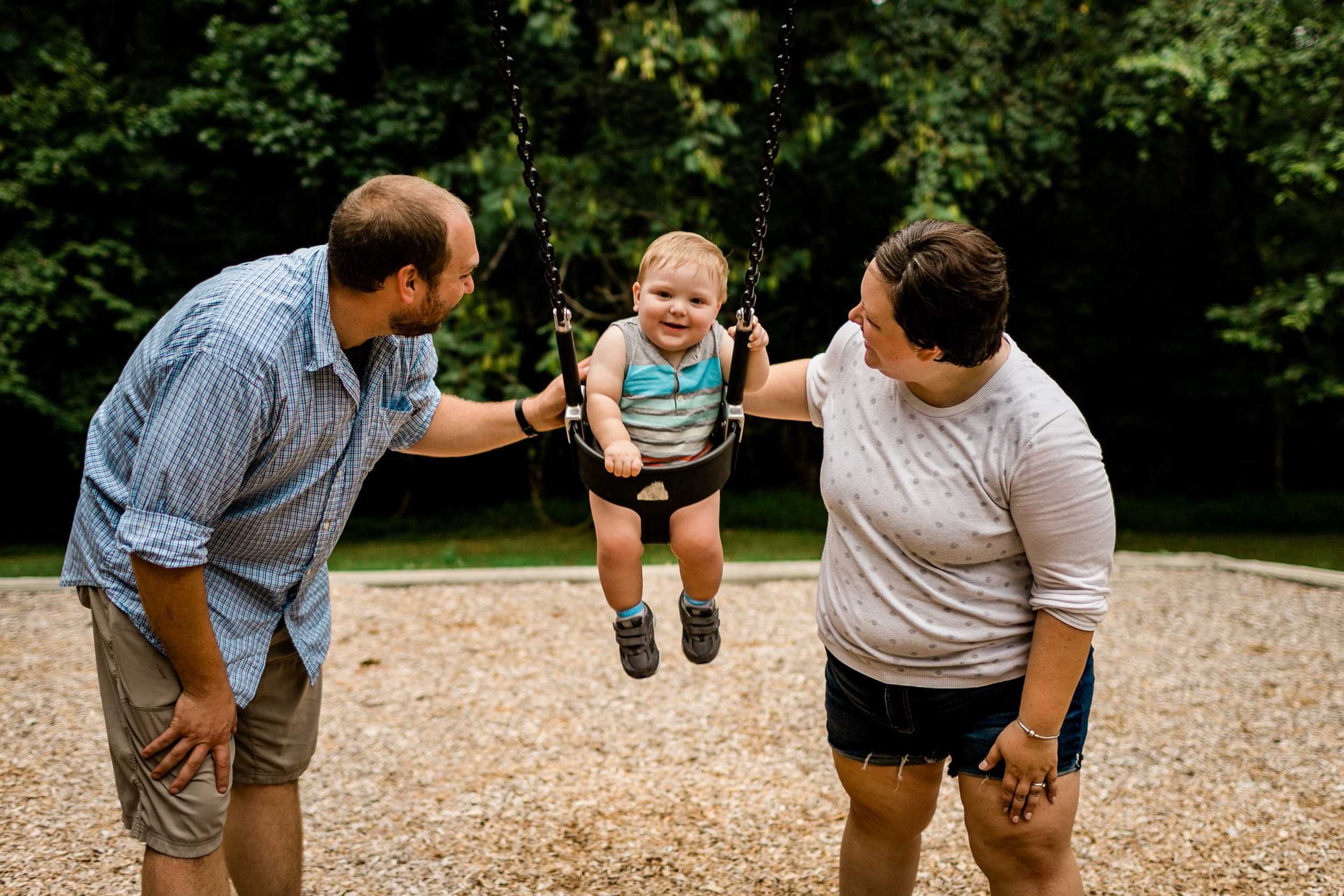 Baby boy swinging with parents | Durham Family Photographer | By G. Lin Photography