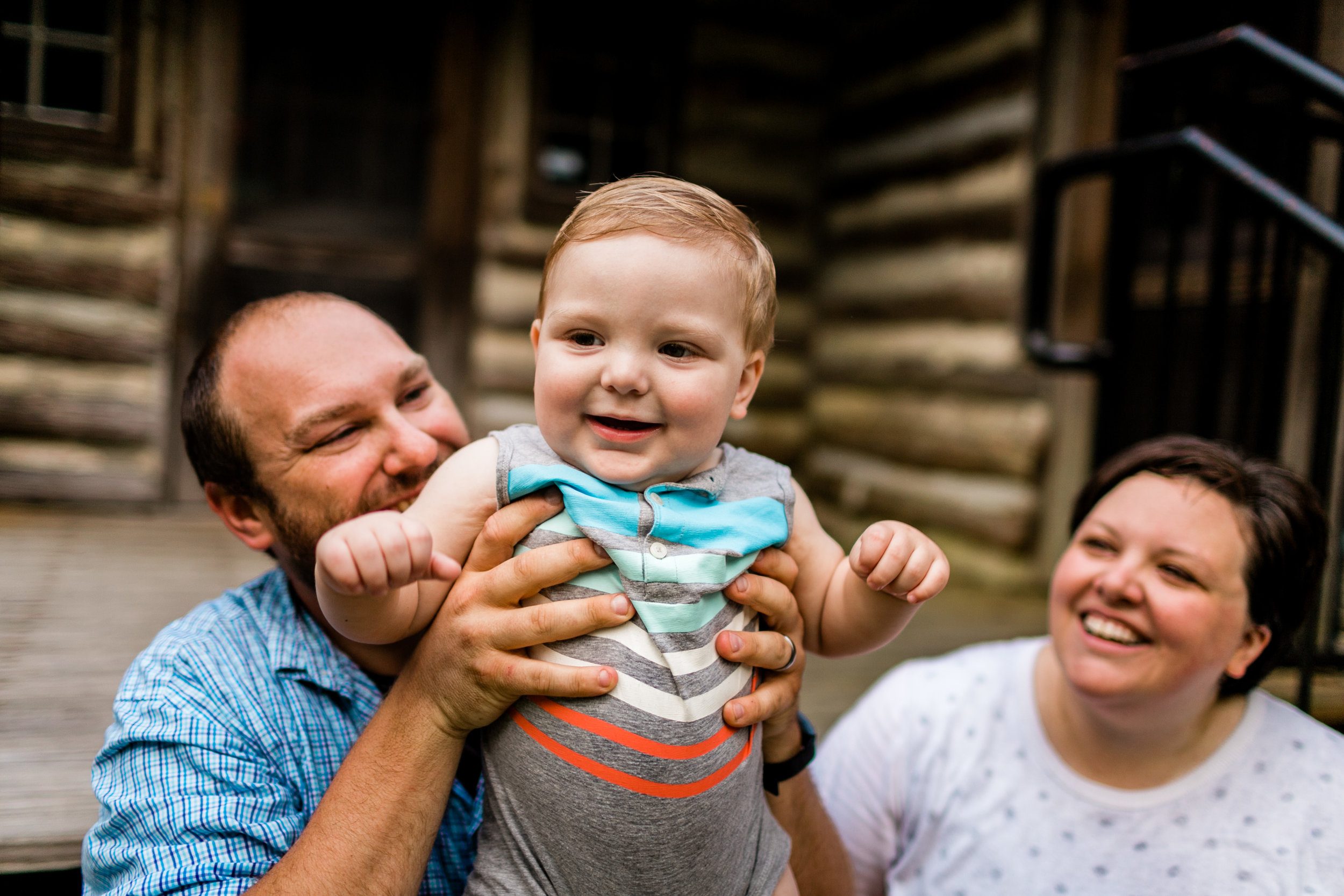 Durham Family Photographer | By G. Lin Photography | Baby boy smiling with parents in the background | Spruce Pine Lodge Bahama NC