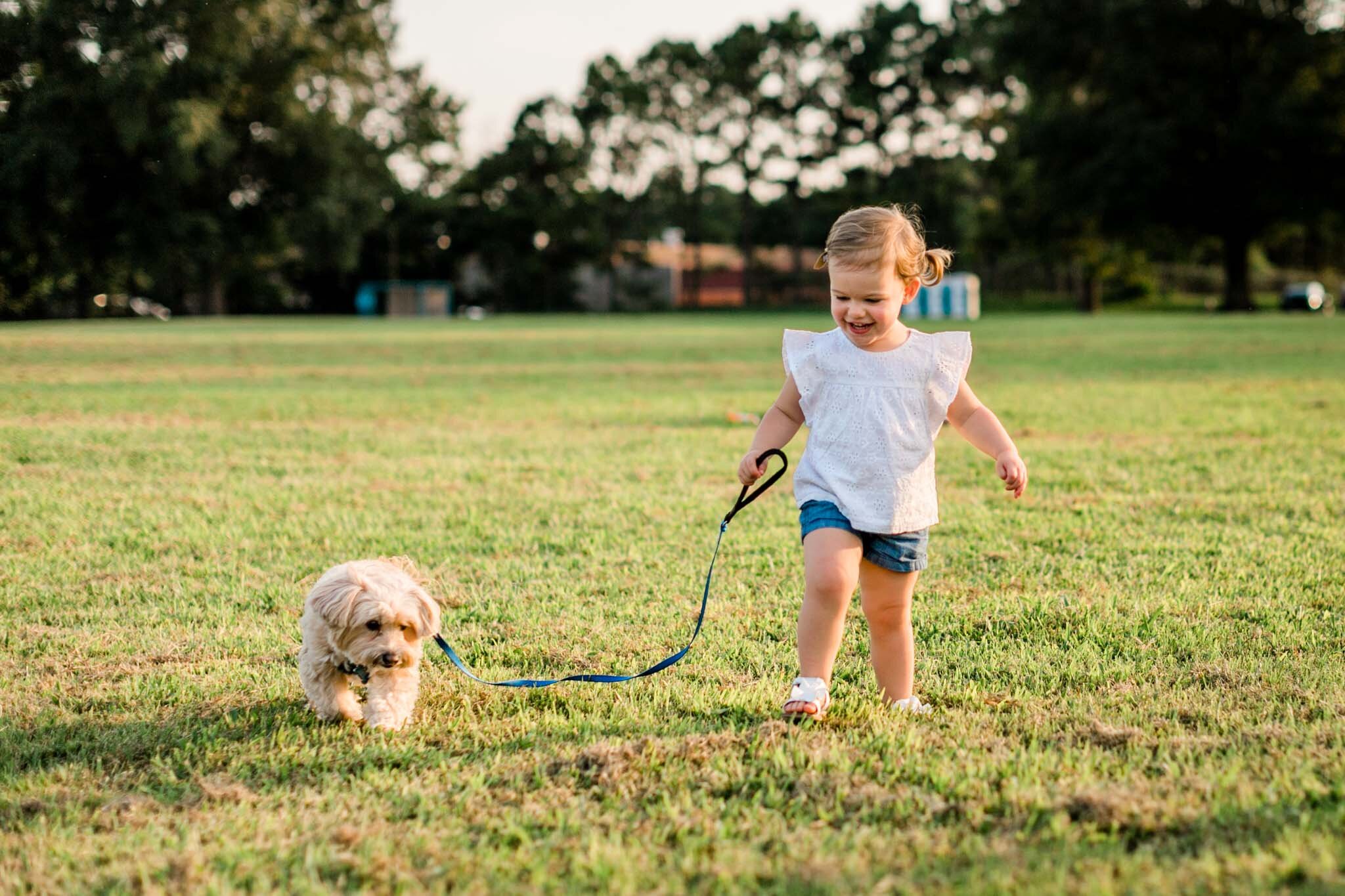 Raleigh Family Photographer | By G. Lin Photography | Little girl walking maltipoo dog
