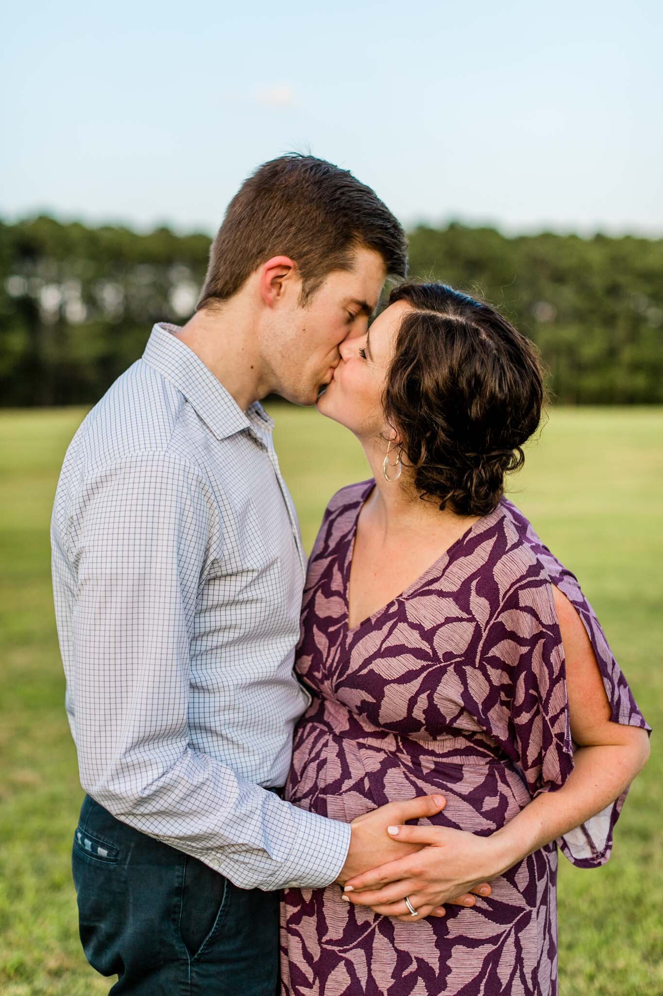 Raleigh Family Photographer | By G. Lin Photography | Couple kissing in open field at Dix Park