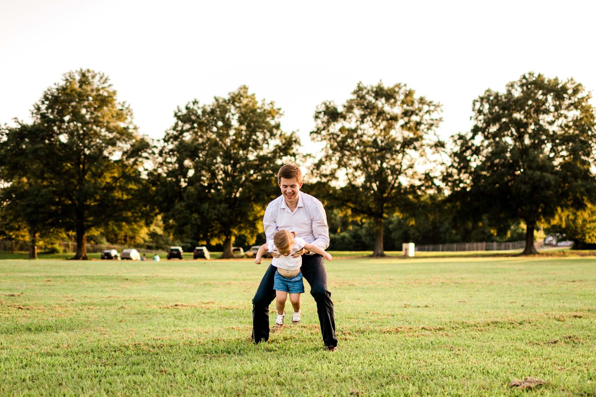 Raleigh Family Photography at Dix Park | By G. Lin Photography | Dad playing with daughter in open field